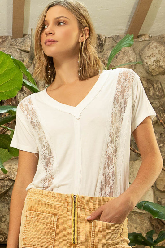 A designed-in v-neck shirt with a relaxed fit, featuring a mix of jersey and lace, offers a stylish and versatile wardrobe option. The v-neck design adds a flattering neckline, while the relaxed fit provides comfort and ease of movement. The combination of soft POL jersey and delicate lace creates a unique contrast of textures, blending comfort with a touch of elegance.  S-L