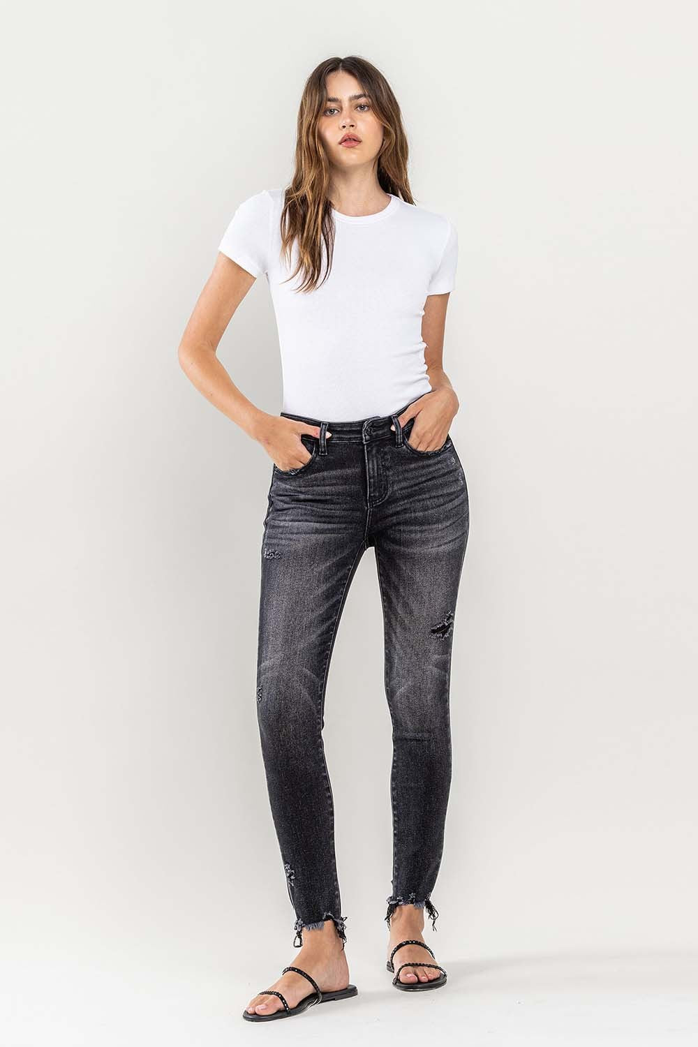 These raw hem cropped skinny jeans are a must-have for any fashion-forward individual. The raw hem adds a touch of edge to the classic skinny jeans silhouette. The cropped length is perfect for showcasing your favorite footwear. 24-32