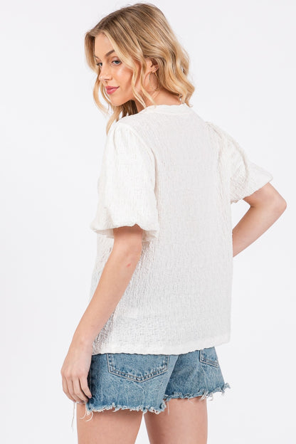 The Textured Puff Sleeve Top is a trendy and feminine top that adds a touch of drama to any outfit. The textured fabric creates visual interest and dimension, making it a standout piece in your wardrobe. The puff sleeves add a playful and romantic vibe to the top, perfect for both casual and dressy occasions. S-L