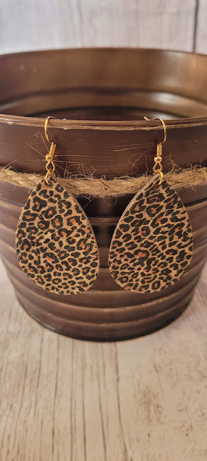 Little Bit Corky Teardrop Cheetah Earrings  Leopard print cork earrings Teardrop shape Brushed gold fish hook dangle earrings Rubber earring back Length 3” Whether you want to be on the wild side or classy this earring set it will add a fun touch to your outfit