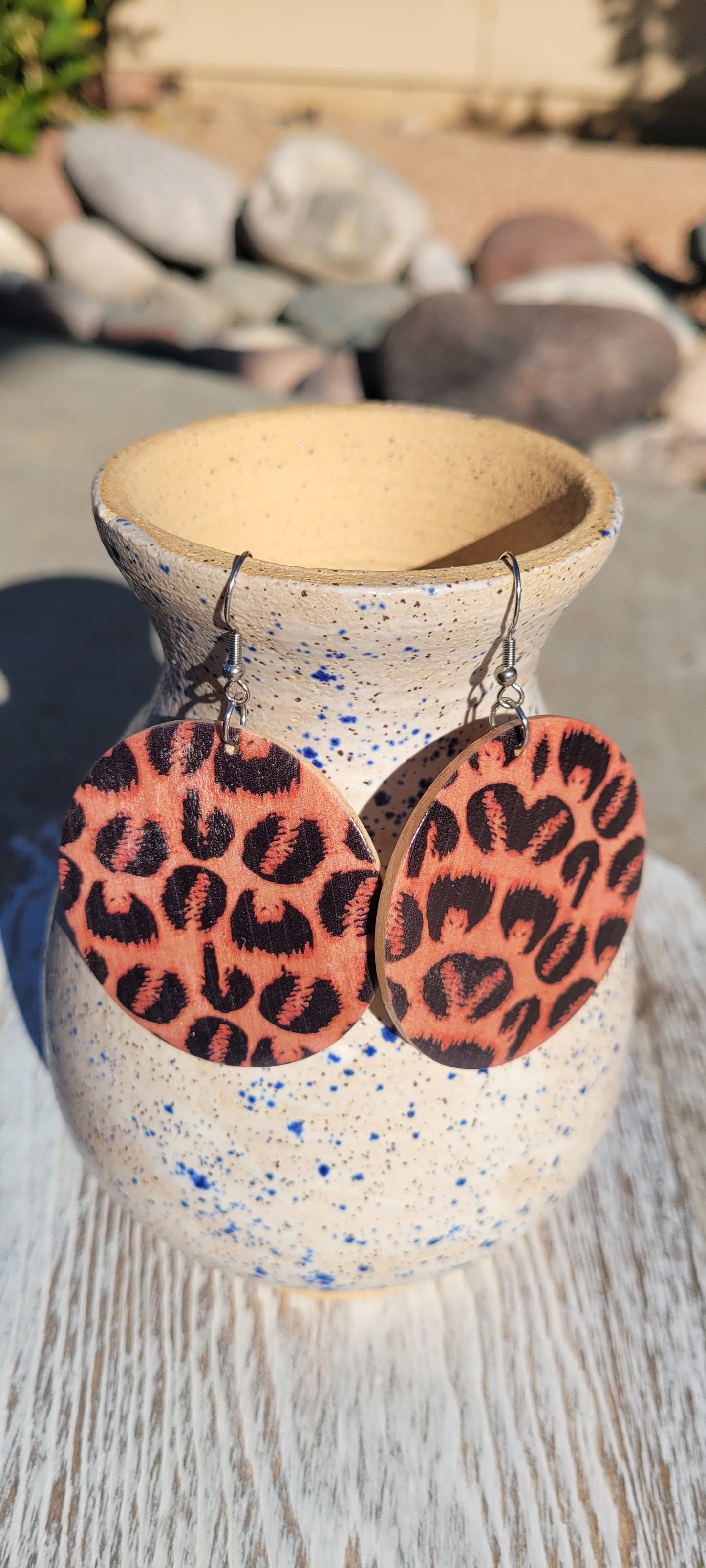 Natural wood color Leopard print Circle shape Silver fish hook dangle earrings Rubber earring back Drop length 2”, diameter 2” Whether you want to be on the wild side or classy this earring set it will add a fun touch to your outfit