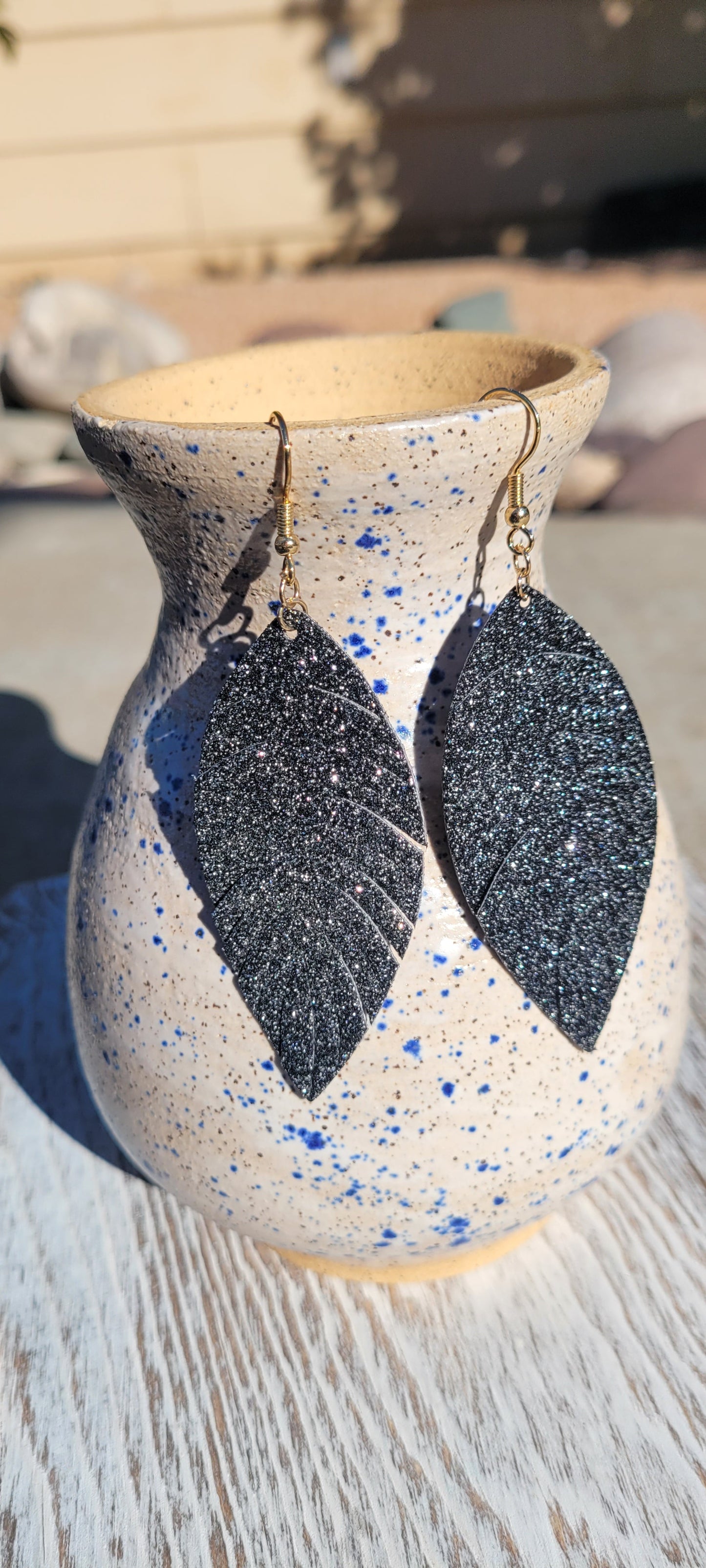 Marquise shape Black sparkle Faux leather Fringed feathers Brushed gold fish hook dangle earrings Rubber earring back Whether you want to be on the wild side or classy this earring set it will add a fun touch to your outfit