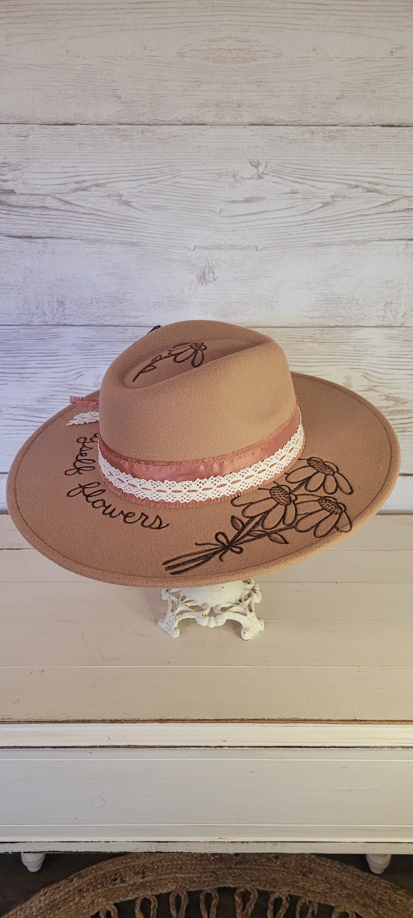 Features "I can by myself flowers" & flowers engraved Frayed rose ribbon, natural lace ribbon with flower brooch & playing card Felt hat Flat brim 65% polyester and 35% cotton Ribbon drawstring for hat size adjustment Head Circumference: 24" Crown Height: 5" Brim Length: 15.75" Brim Width: 14.5" Branded & numbered inside crown Custom burned & engraved by Kayla