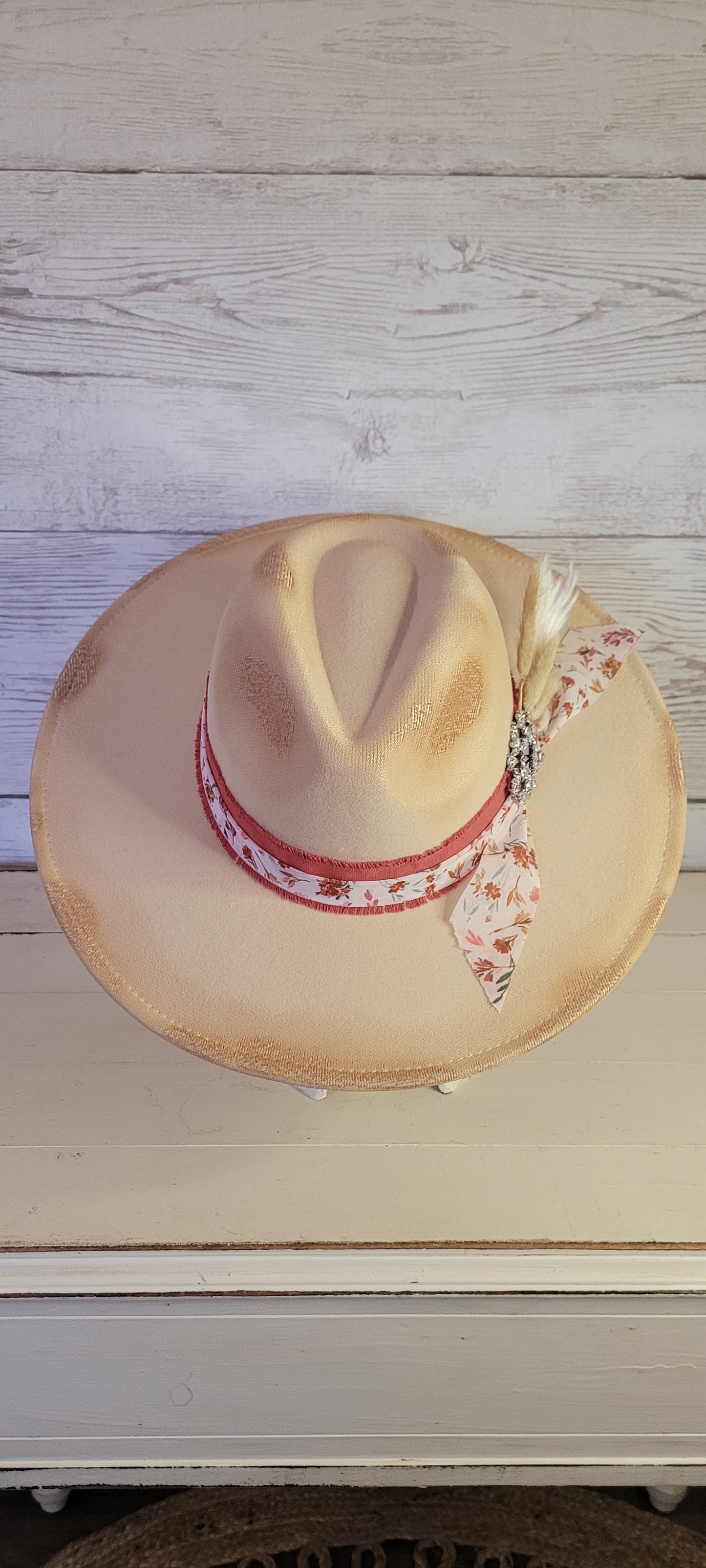 Lace ribbon, sheer floral ribbon, cattails, pampas & rhinestone brooch Felt hat Flat brim 65% polyester and 35% cotton Ribbon drawstring for hat size adjustment Head Circumference: 24" Crown Height: 5" Brim Length: 15.75" Brim Width: 14.5" Branded & numbered inside crown Custom designed by Kayla