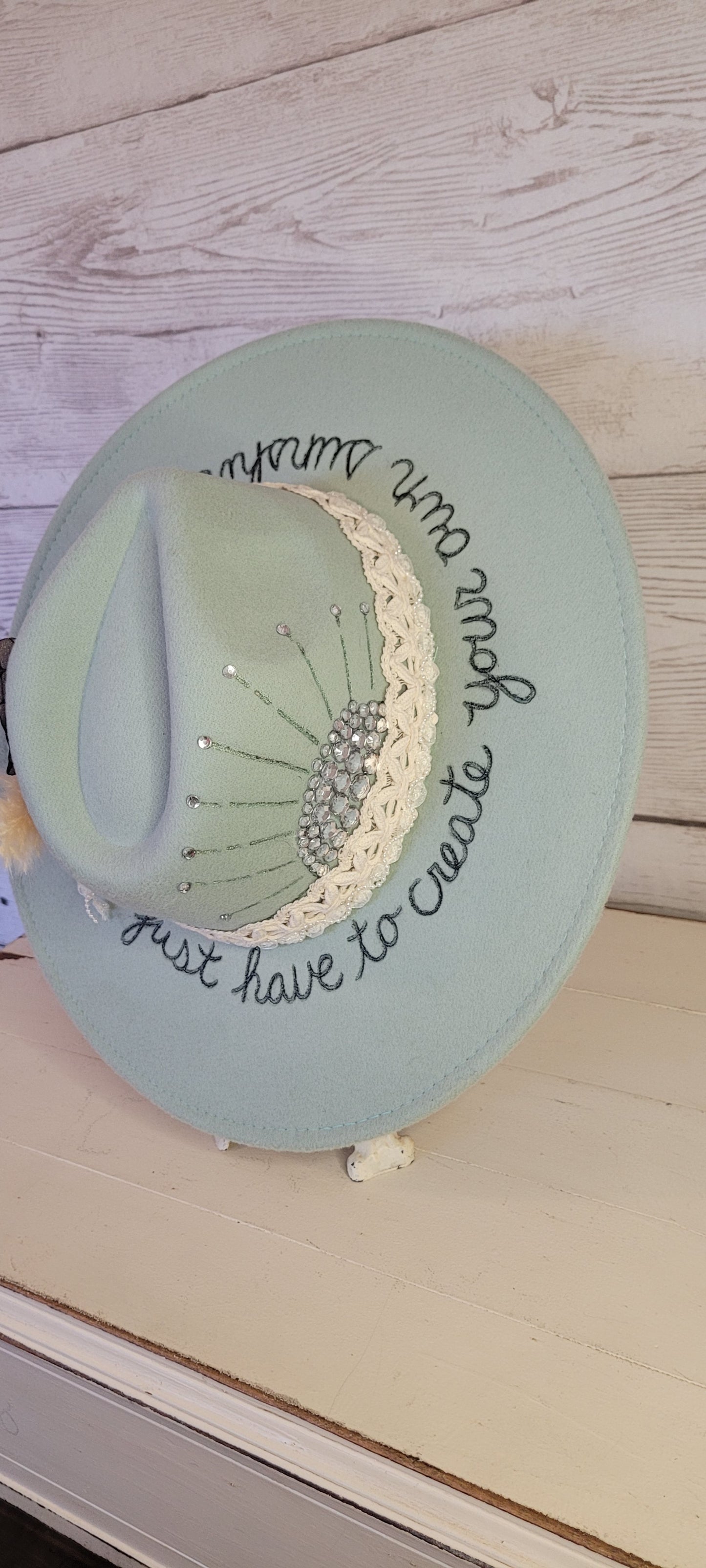 Features sunshine & "somedays you just have to create your own sunshine" engraved Natural lace ribbon, pearl lace ribbon, pampas, playing card with rhinestones Felt hat Flat brim 65% polyester and 35% cotton Ribbon drawstring for hat size adjustment Head Circumference: 24" Crown Height: 5" Brim Length: 15.75" Brim Width: 14.5" Branded & numbered inside crown Custom burned & engraved by Kayla