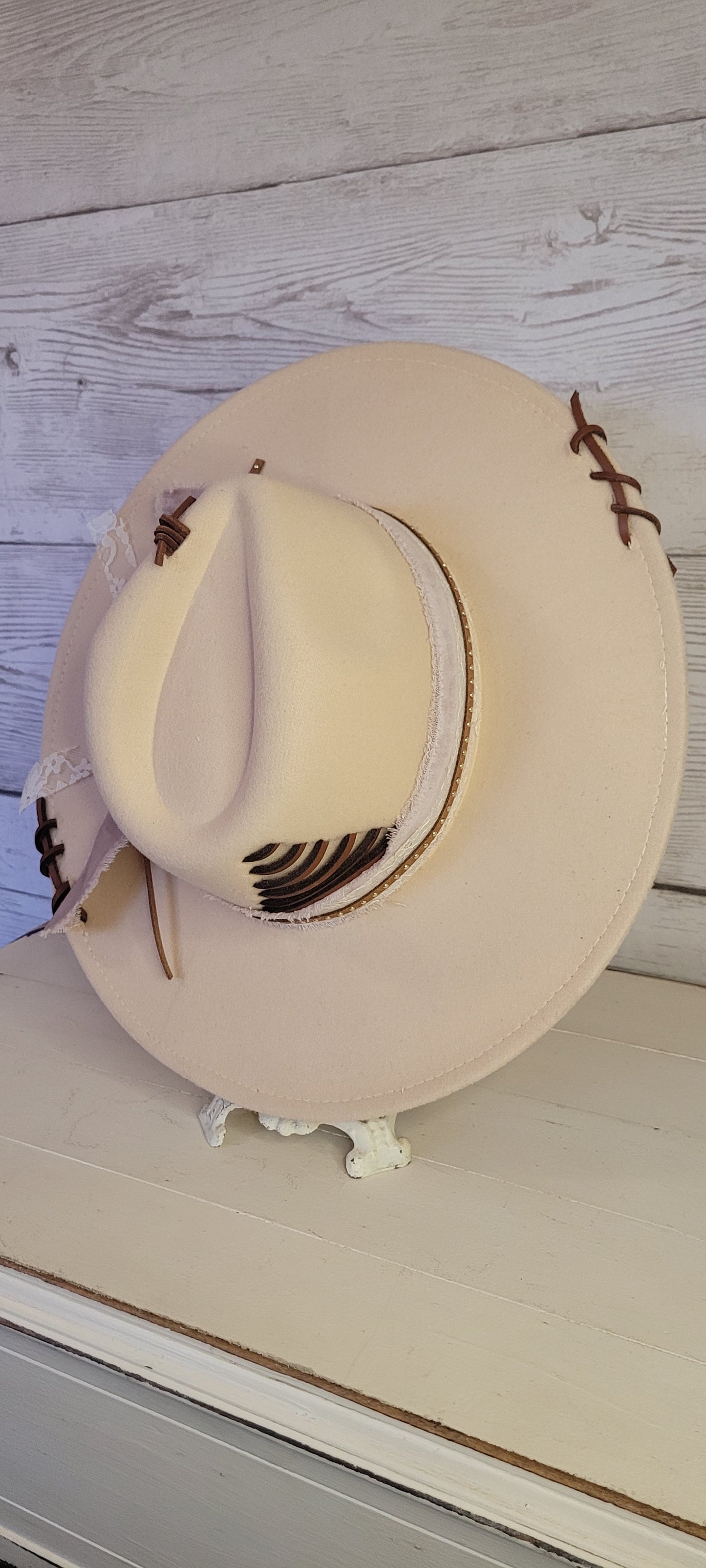 Features velvet mushroom ribbon, lace ribbon, leather band with metal detailing, & leather sewn into brim & crown Felt hat Flat brim 65% polyester and 35% cotton Ribbon drawstring for hat size adjustment Head Circumference: 24" Crown Height: 5" Brim Length: 15.75" Brim Width: 14.5" Branded & numbered inside crown Custom designed by Kayla