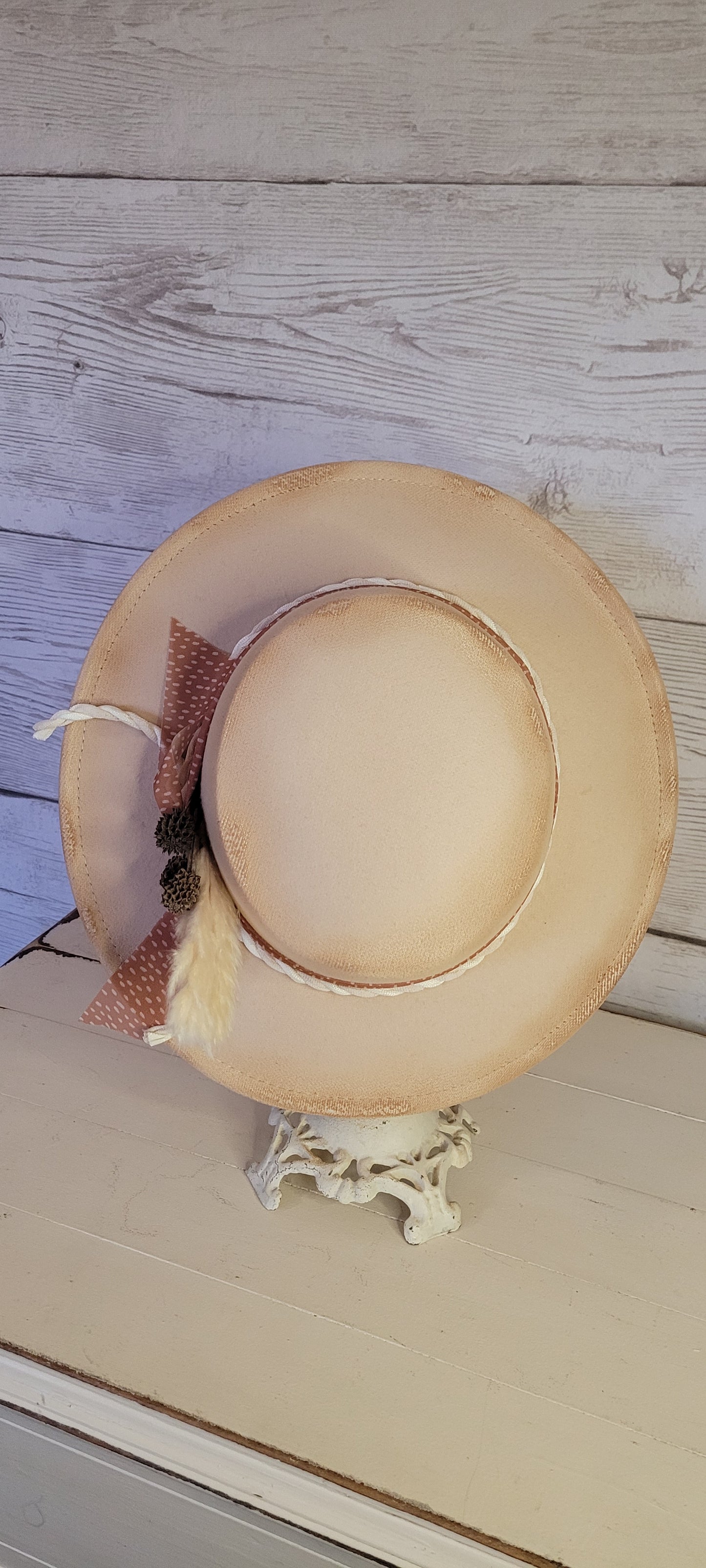 Sheer ribbon, natural gauze rope, pine cones & pampas Felt hat Flat brim 100% polyester Ribbon drawstring for hat size adjustment Head Circumference: 24" Crown Height: 3.5" Brim Length: 13.5" Brim Width: 12.75" Branded & numbered inside crown Custom burned by Kayla