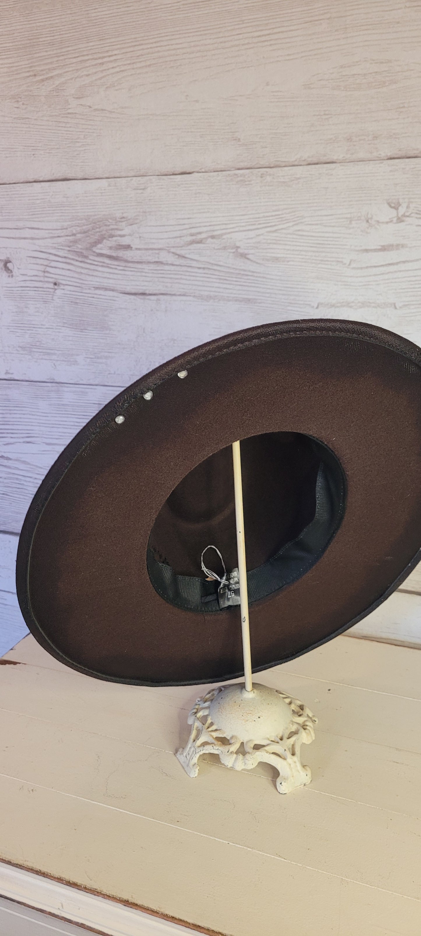 Features natural lace ribbon, corduroy ribbon, feather, playing cards, pistol brooch, & rhinestone beads Felt hat Flat brim 65% polyester and 35% cotton Ribbon drawstring for hat size adjustment Head Circumference: 24" Crown Height: 5" Brim Length: 15.75" Brim Width: 14.5" Branded & numbered inside crown Custom designed by Kayla
