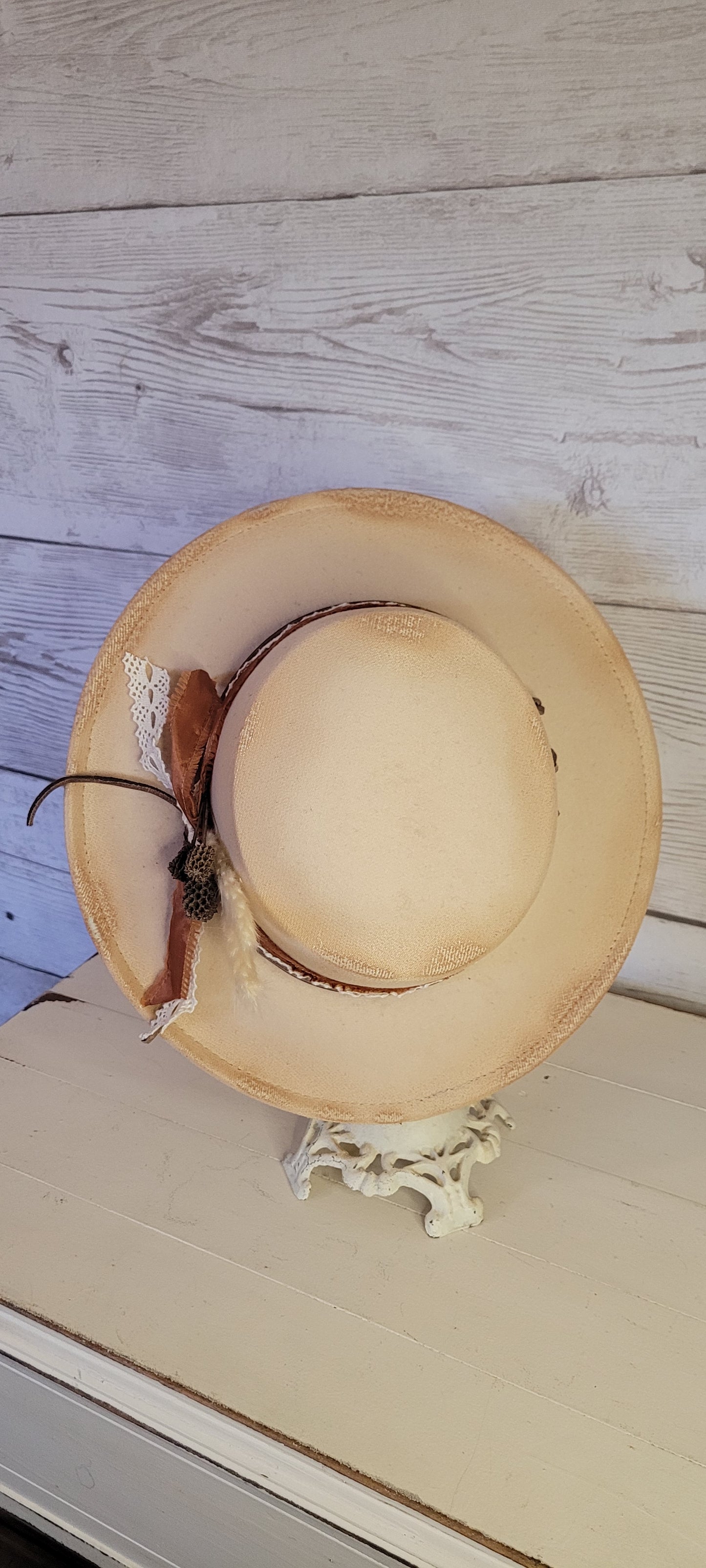 Lace ribbon, frayed lace ribbon, leather band, pampas, pine cones Felt hat Flat brim 100% polyester Ribbon drawstring for hat size adjustment Head Circumference: 24" Crown Height: 3.5" Brim Length: 13.5" Brim Width: 12.75" Branded & numbered inside crown Custom burned & engraved by Kayla