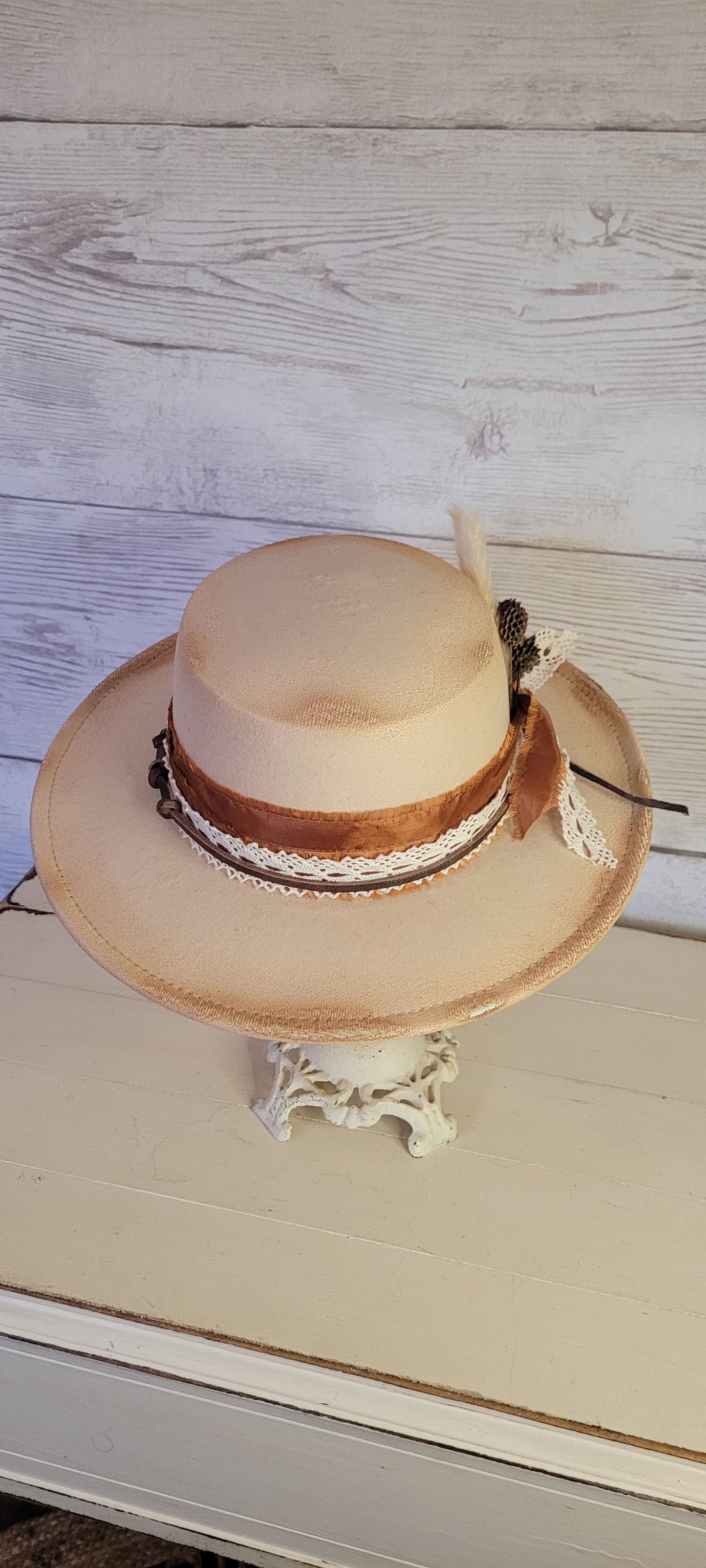 Lace ribbon, frayed lace ribbon, leather band, pampas, pine cones Felt hat Flat brim 100% polyester Ribbon drawstring for hat size adjustment Head Circumference: 24" Crown Height: 3.5" Brim Length: 13.5" Brim Width: 12.75" Branded & numbered inside crown Custom burned & engraved by Kayla