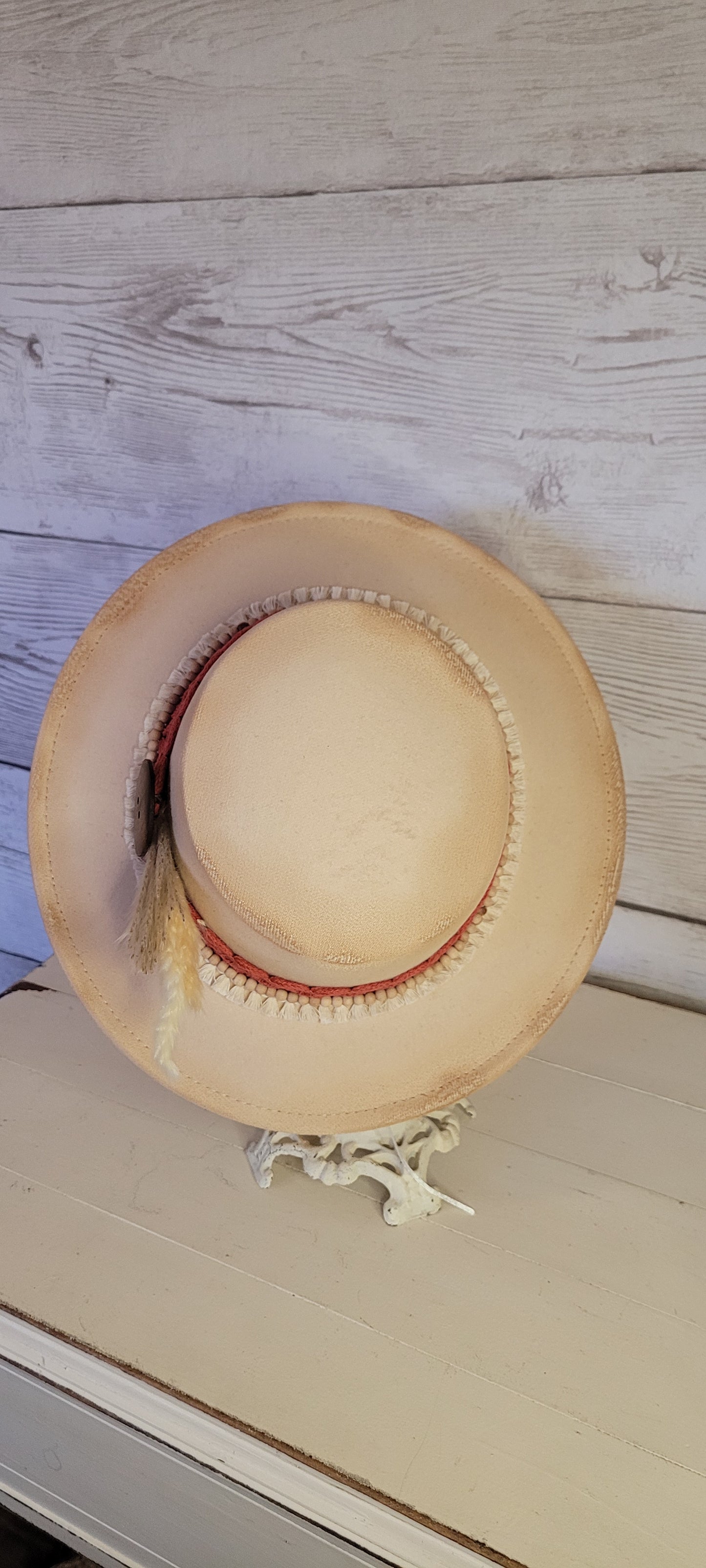 Lace ribbon, tassel ribbon, wooden bead band, button, & pampas Felt hat Flat brim 100% polyester Ribbon drawstring for hat size adjustment Head Circumference: 24" Crown Height: 3.5" Brim Length: 13.5" Brim Width: 12.75" Branded & numbered inside crown Custom burned by Kayla
