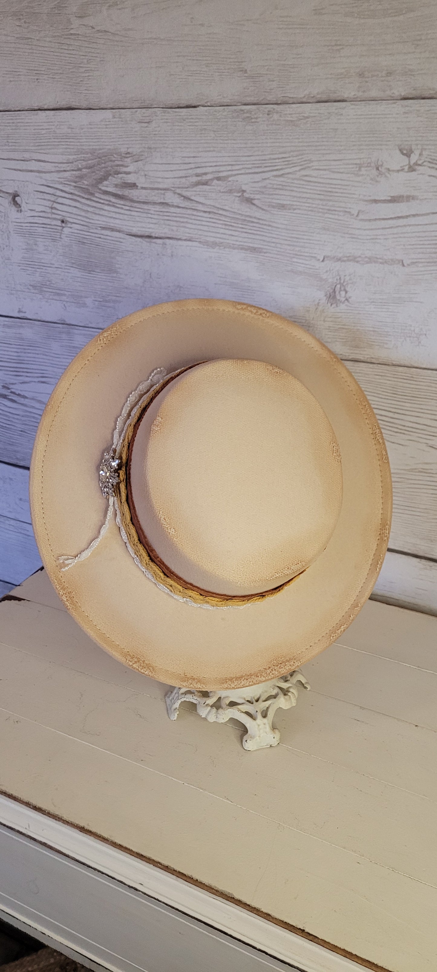 Lace ribbon, frayed lace ribbon, pearl lace ribbon, and rhinestone crystal brooch Felt hat Flat brim 100% polyester Ribbon drawstring for hat size adjustment Head Circumference: 24" Crown Height: 3.5" Brim Length: 13.5" Brim Width: 12.75" Branded & numbered inside crown Custom burned by Kayla