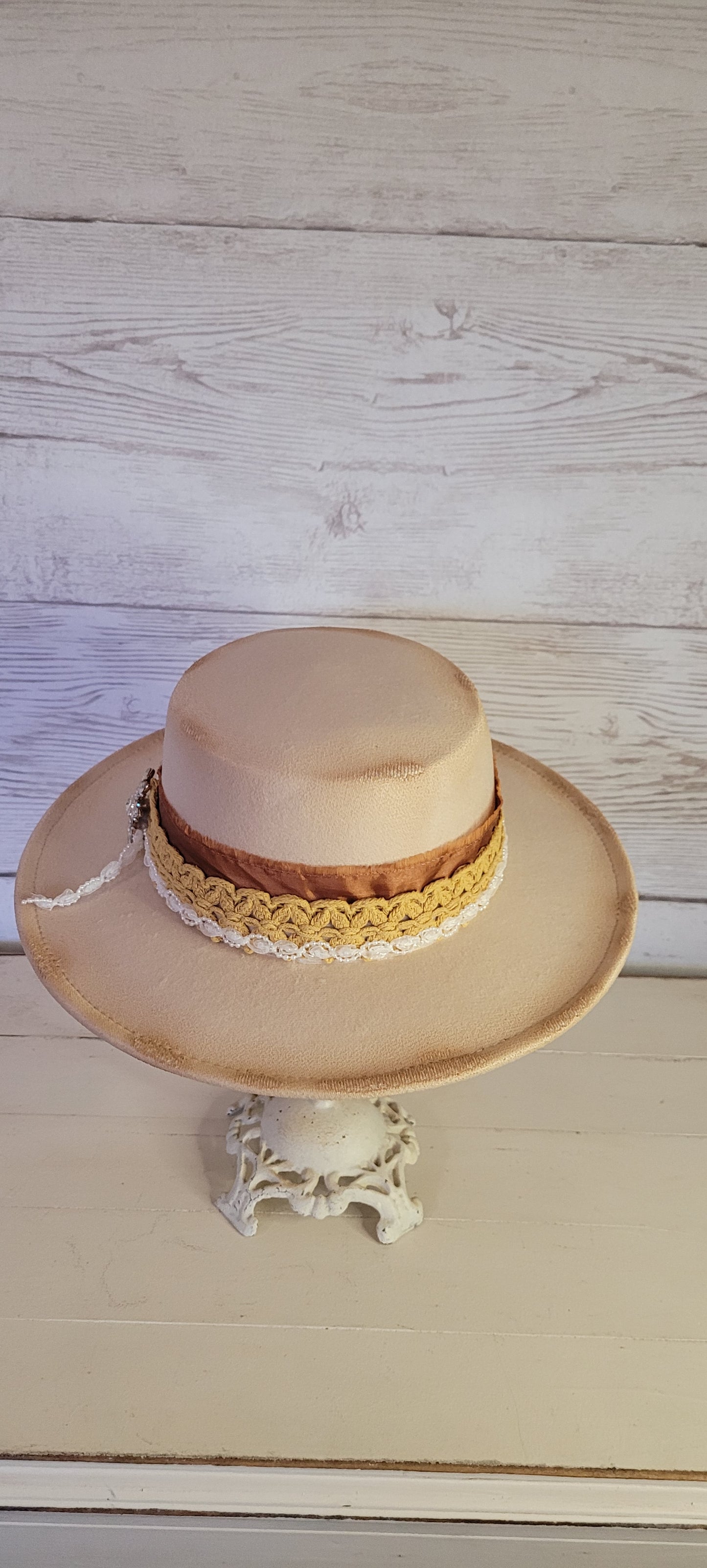 Lace ribbon, frayed lace ribbon, pearl lace ribbon, and rhinestone crystal brooch Felt hat Flat brim 100% polyester Ribbon drawstring for hat size adjustment Head Circumference: 24" Crown Height: 3.5" Brim Length: 13.5" Brim Width: 12.75" Branded & numbered inside crown Custom burned by Kayla