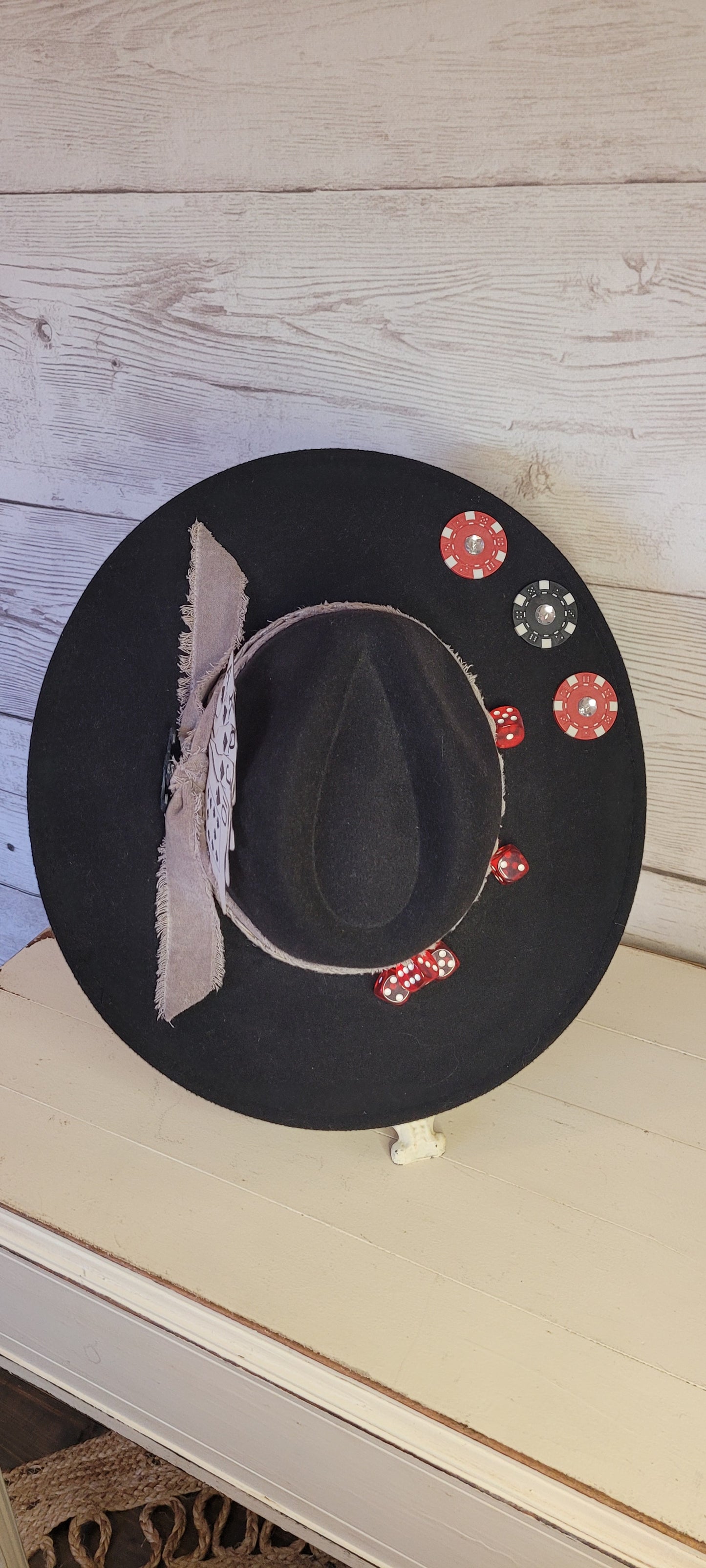 Features poker chips, dice, rhinestones, playing cards, natural frayed & lace ribbon, & metal horseshoe Felt hat Flat brim 35% cotton and 65% polyester Ribbon drawstring for hat size adjustment Head Circumference: 24" Crown Height: 5" Brim Length: 15.75" Brim Width: 14.5" Branded & numbered inside crown Custom designed by Kayla