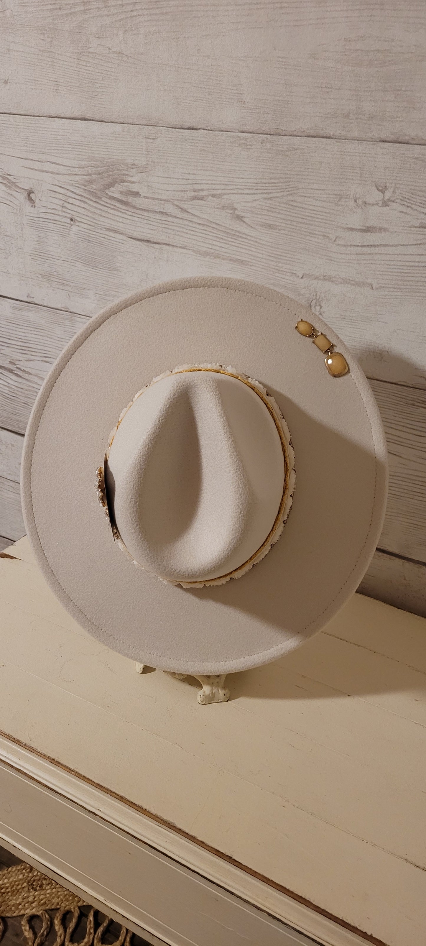 Lace ribbon, sheer floral ribbon, golden seed beads, playing card & rhinestone brooches Felt hat Flat brim 65% polyester and 35% cotton Ribbon drawstring for hat size adjustment Head Circumference: 24" Crown Height: 5" Brim Length: 15.75" Brim Width: 14.5" Branded & numbered inside crown Custom designed by Kayla