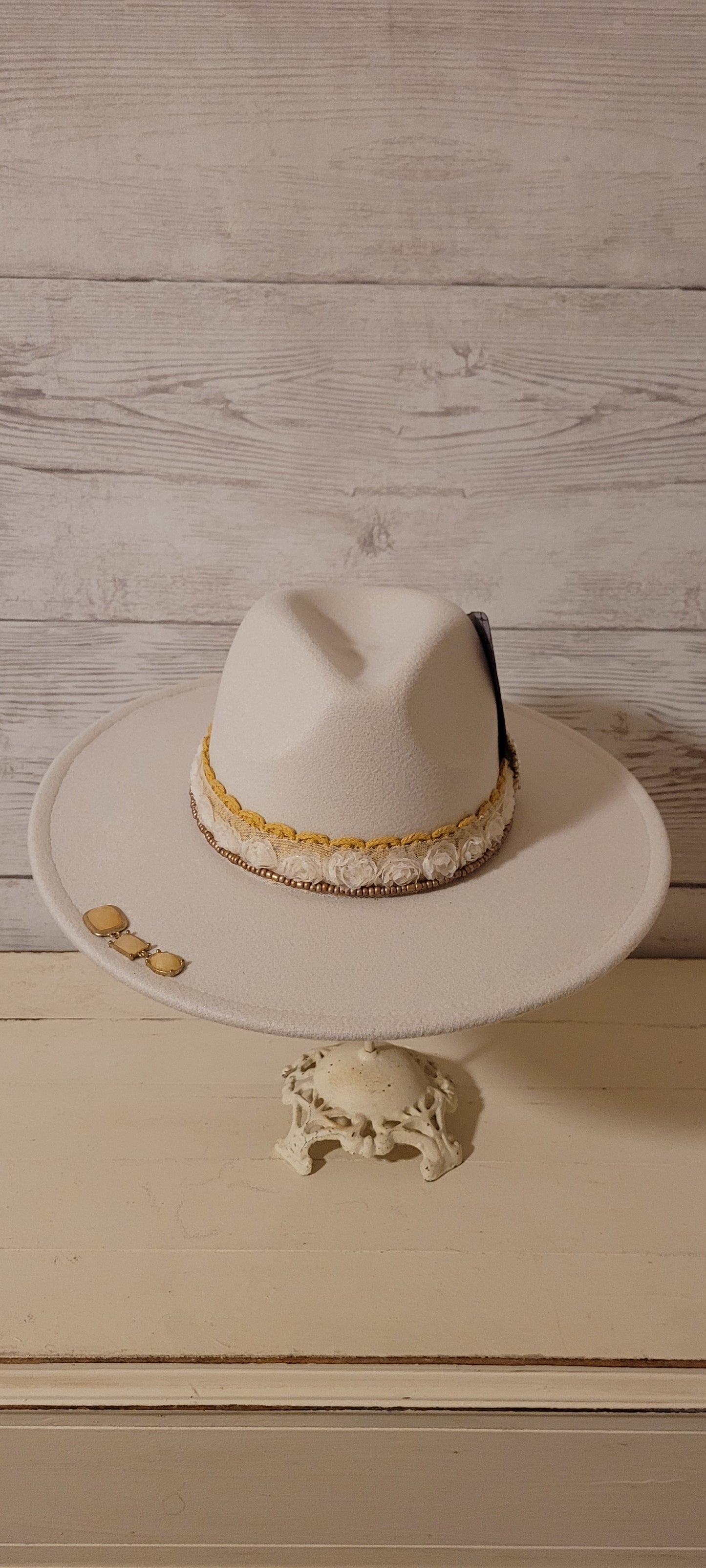 Lace ribbon, sheer floral ribbon, golden seed beads, playing card & rhinestone brooches Felt hat Flat brim 65% polyester and 35% cotton Ribbon drawstring for hat size adjustment Head Circumference: 24" Crown Height: 5" Brim Length: 15.75" Brim Width: 14.5" Branded & numbered inside crown Custom designed by Kayla