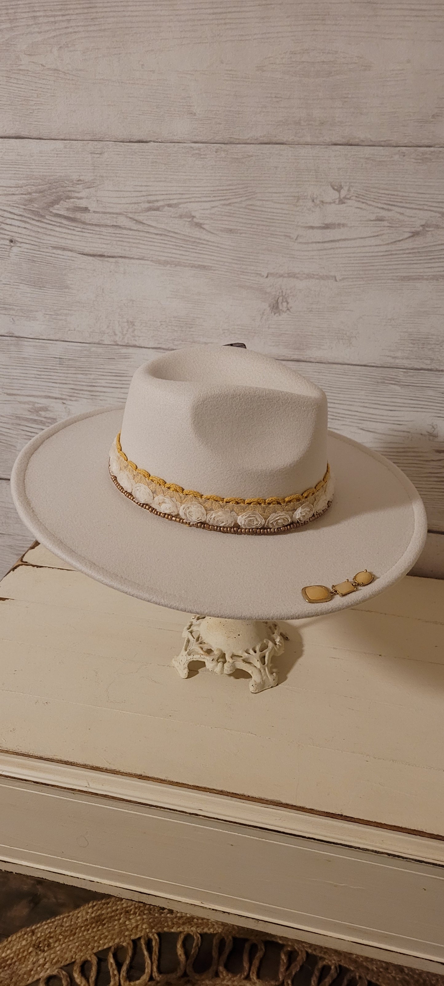 Lace ribbon, sheer floral ribbon, golden seed beads, playing card & rhinestone brooches Felt hat Flat brim 65% polyester and 35% cotton Ribbon drawstring for hat size adjustment Head Circumference: 24" Crown Height: 5" Brim Length: 15.75" Brim Width: 14.5" Branded & numbered inside crown Custom designed by Kayla