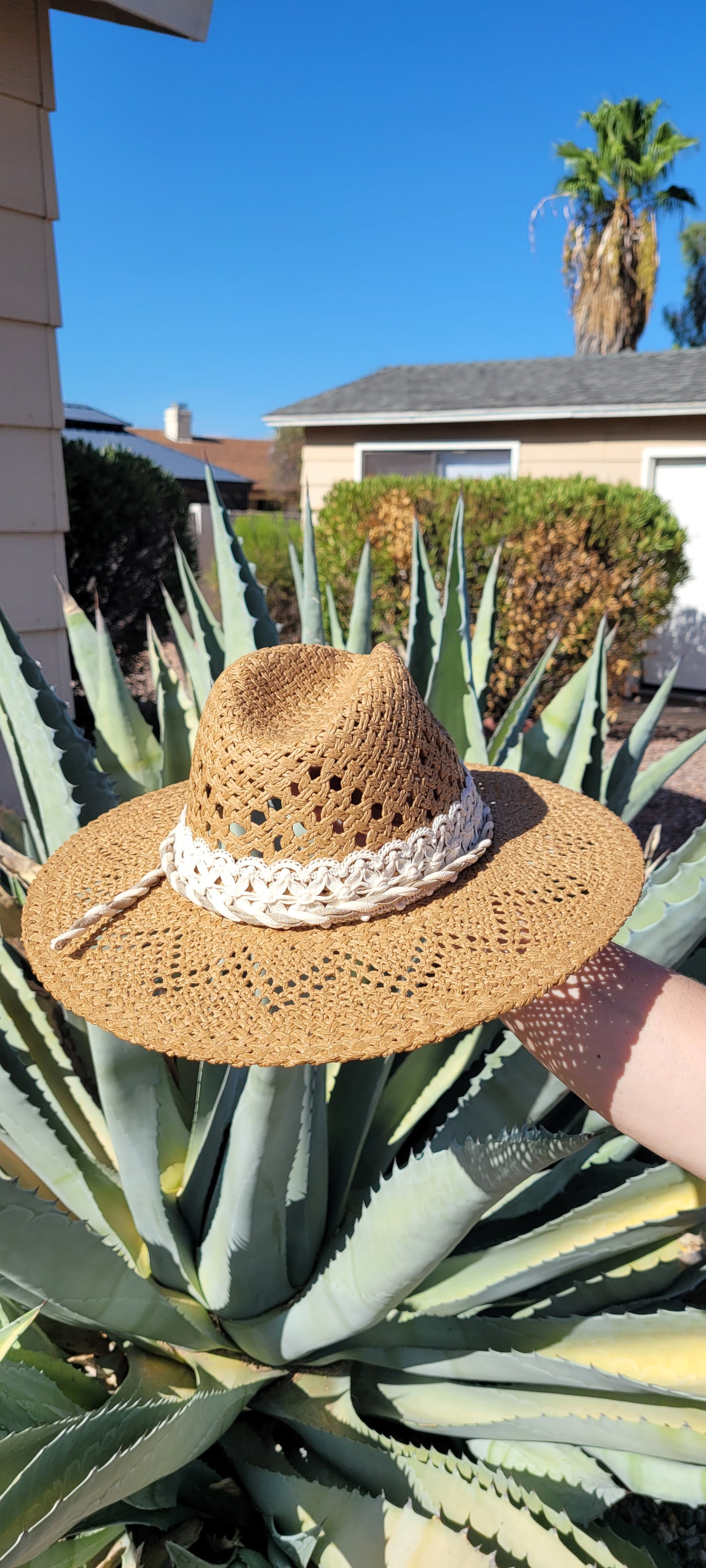 Lace ribbon, twisted gauze, metal horseshoes Straw hat Flat brim 65% polyester and 35% cotton Ribbon drawstring for hat size adjustment Head Circumference: 24" Crown Height: 5" Brim Length: 15.75" Brim Width: 14.75" Branded & numbered inside crown Custom designed by Kayla