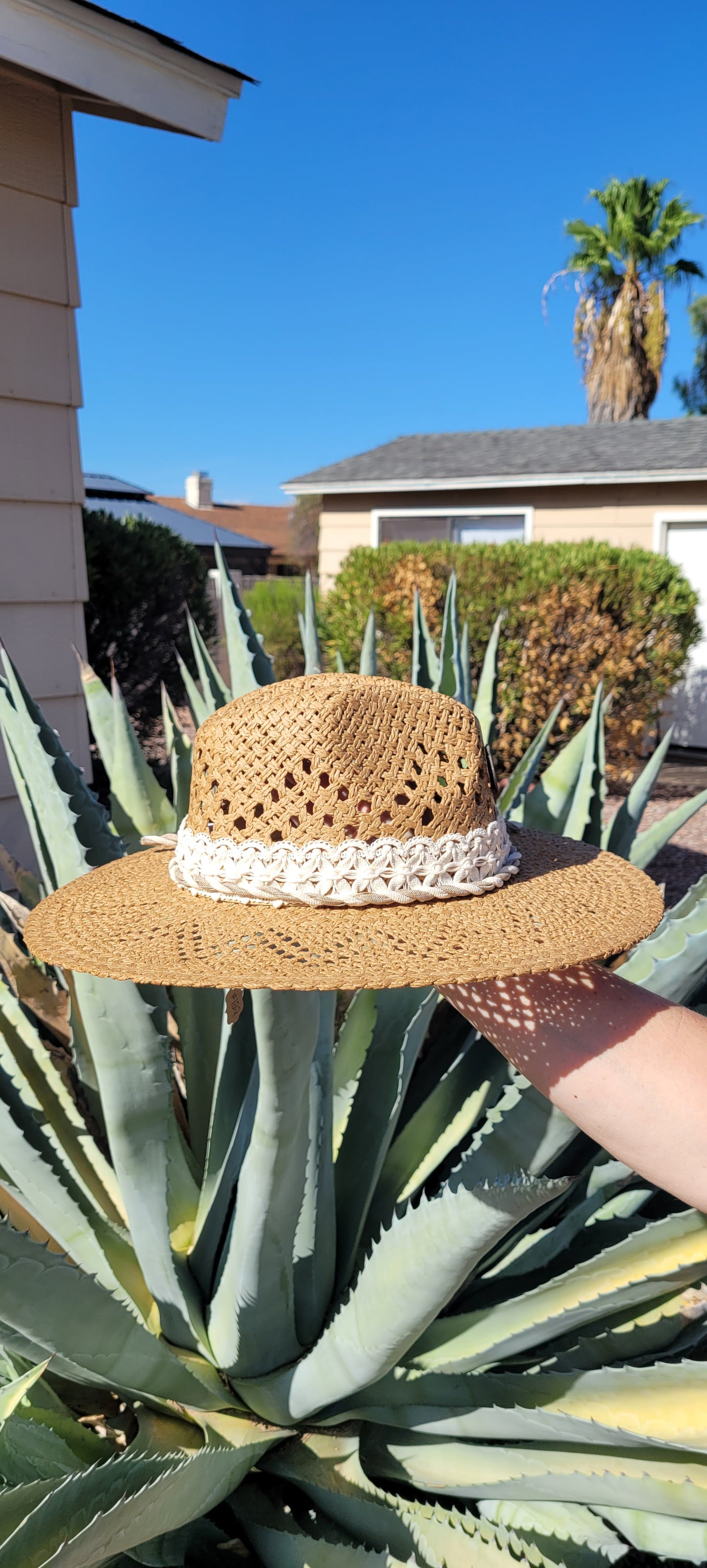 Lace ribbon, twisted gauze, metal horseshoes Straw hat Flat brim 65% polyester and 35% cotton Ribbon drawstring for hat size adjustment Head Circumference: 24" Crown Height: 5" Brim Length: 15.75" Brim Width: 14.75" Branded & numbered inside crown Custom designed by Kayla