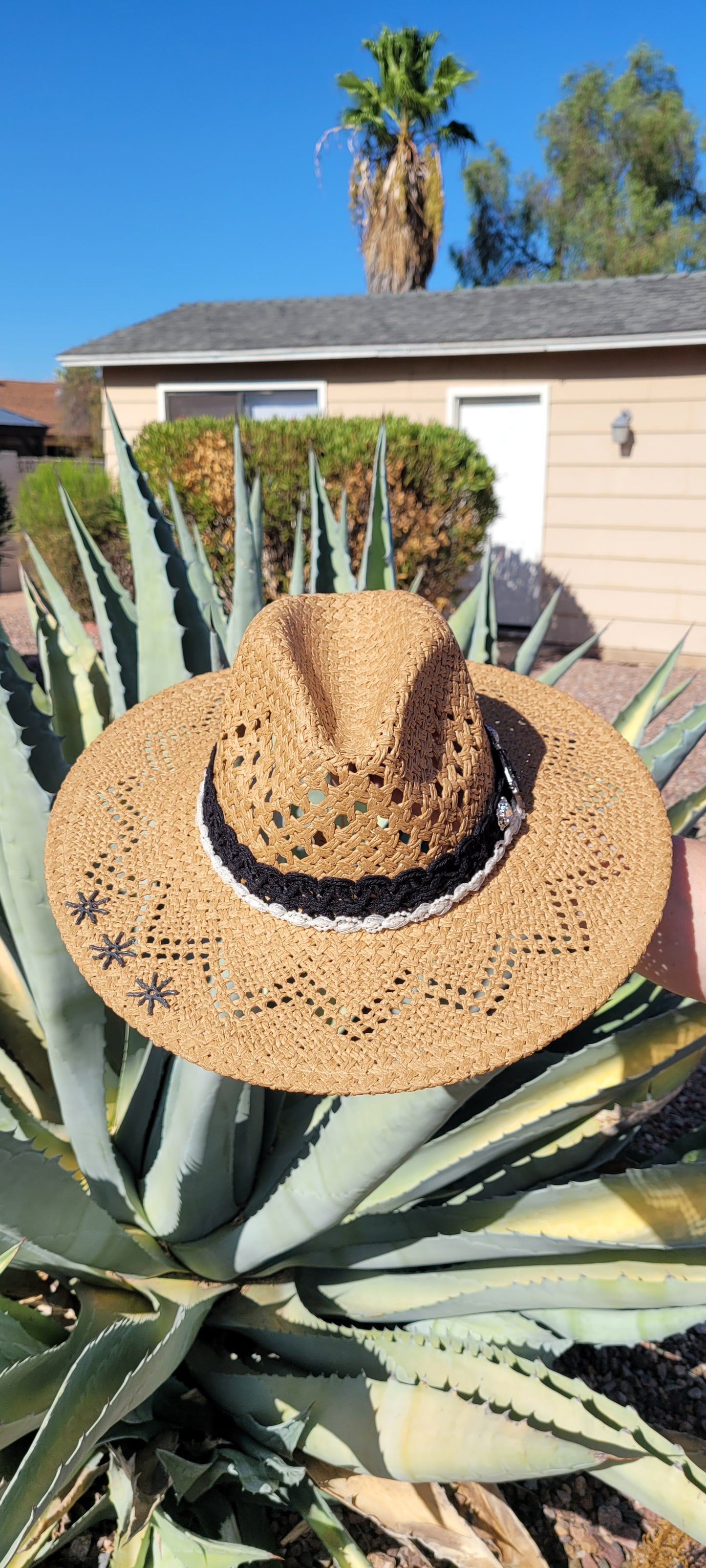 Lace ribbon, pearl ribbon, rowel (boot spur) pistol & decorative brooches Straw hat Flat brim 65% polyester and 35% cotton Ribbon drawstring for hat size adjustment Head Circumference: 24" Crown Height: 5" Brim Length: 15.75" Brim Width: 14.75" Branded & numbered inside crown Custom designed by Kayla