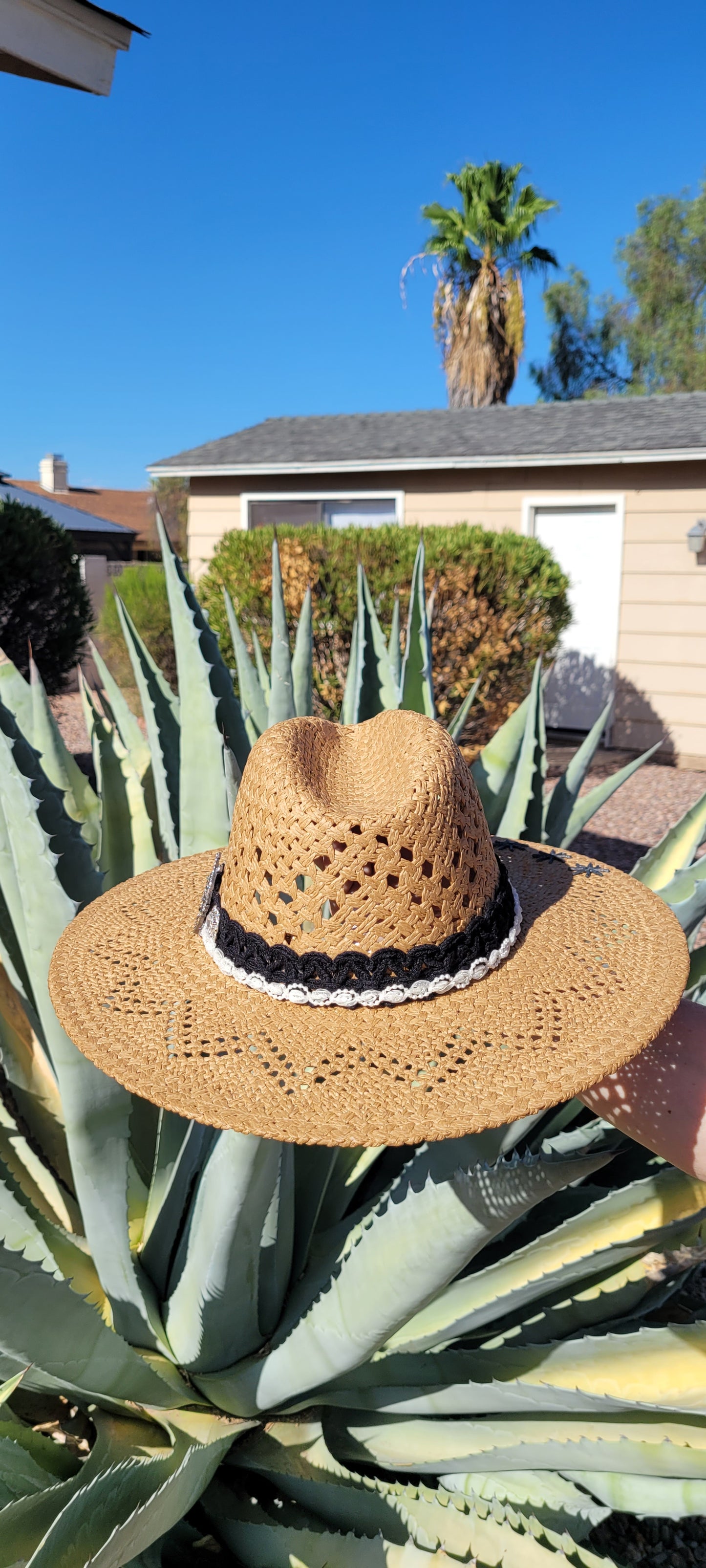 Lace ribbon, pearl ribbon, rowel (boot spur) pistol & decorative brooches Straw hat Flat brim 65% polyester and 35% cotton Ribbon drawstring for hat size adjustment Head Circumference: 24" Crown Height: 5" Brim Length: 15.75" Brim Width: 14.75" Branded & numbered inside crown Custom designed by Kayla