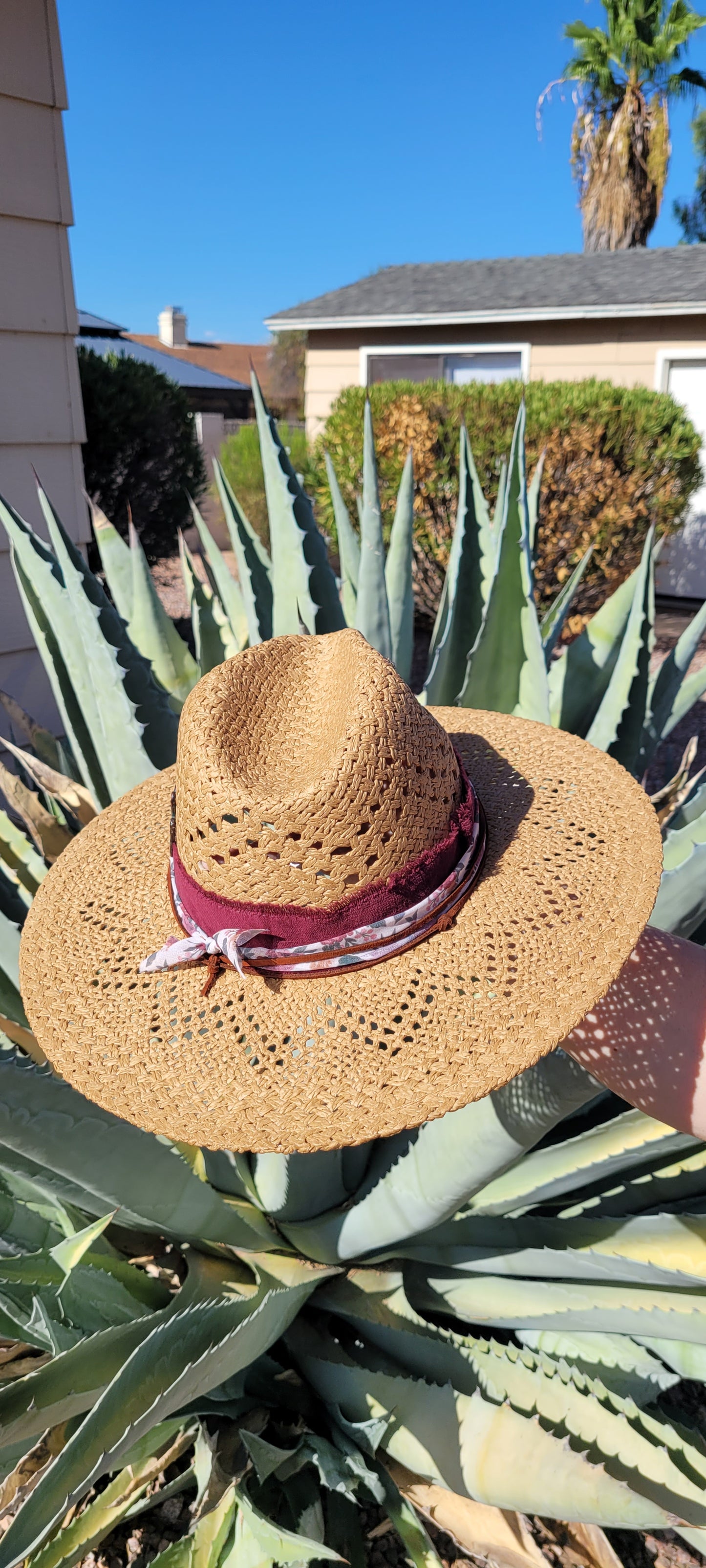 Features frayed velvet ribbon, sheer floral ribbon, suede band, saguaro cactus & flower brooches Straw hat Flat brim 65% polyester and 35% cotton Ribbon drawstring for hat size adjustment Head Circumference: 24" Crown Height: 5" Brim Length: 15.75" Brim Width: 14.75" Branded & numbered inside crown Custom designed by Kayla