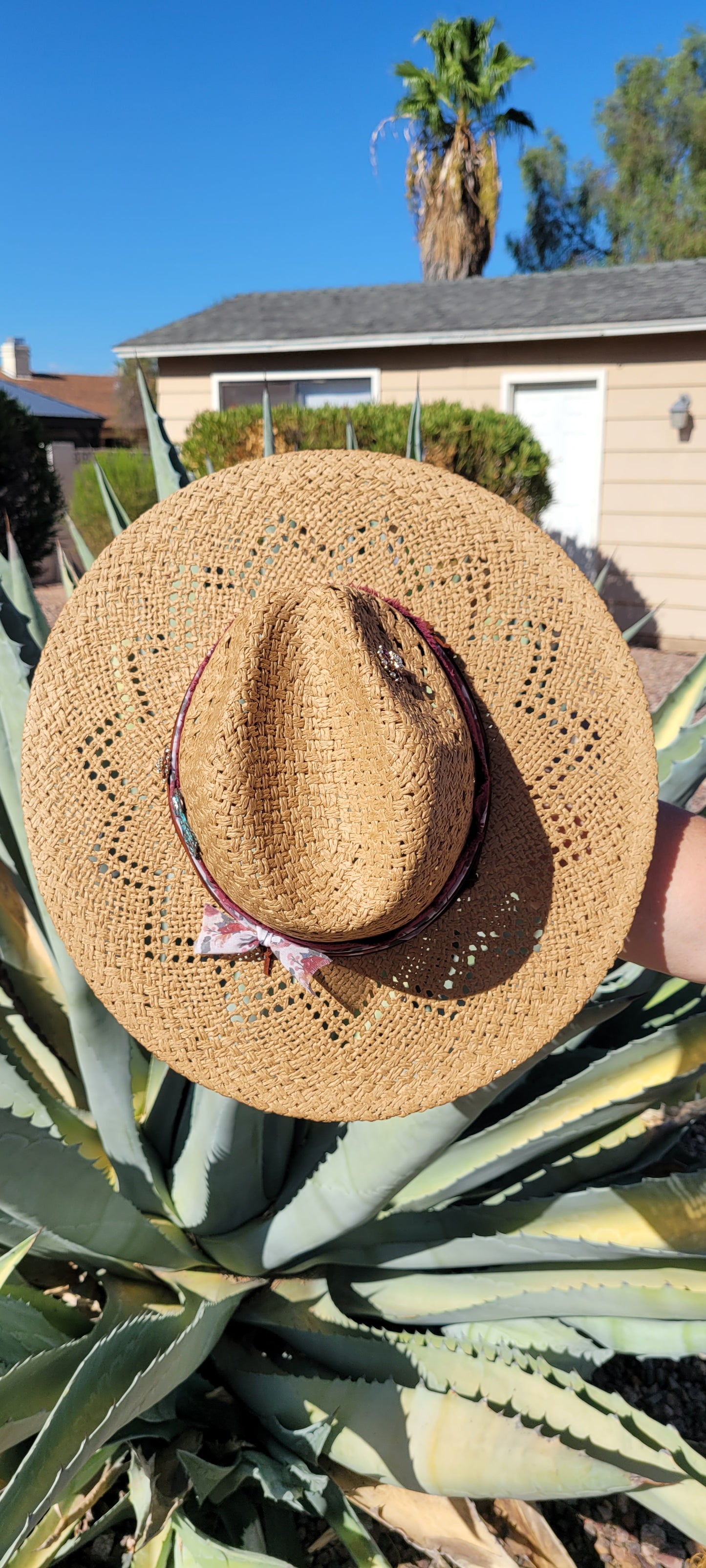 Features frayed velvet ribbon, sheer floral ribbon, suede band, saguaro cactus & flower brooches Straw hat Flat brim 65% polyester and 35% cotton Ribbon drawstring for hat size adjustment Head Circumference: 24" Crown Height: 5" Brim Length: 15.75" Brim Width: 14.75" Branded & numbered inside crown Custom designed by Kayla