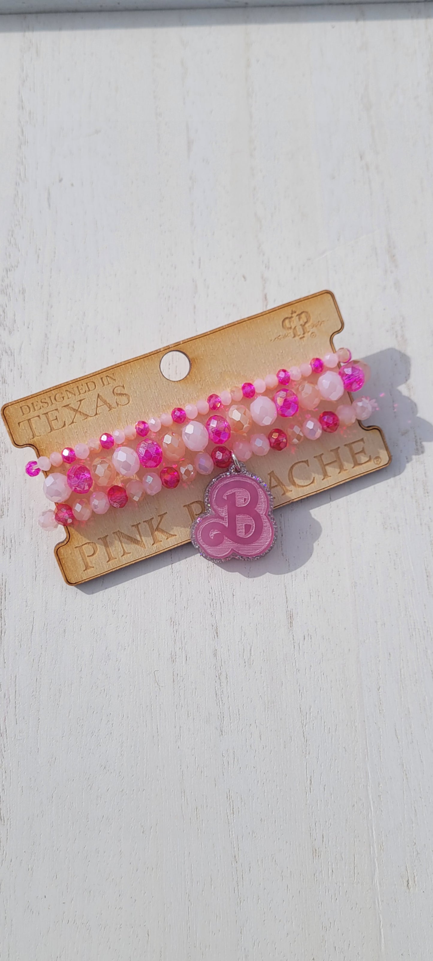 Pink Panache Earrings Color: 3-strand pink tone bracelet with silver glitter & dark pink "B" Limited supply!