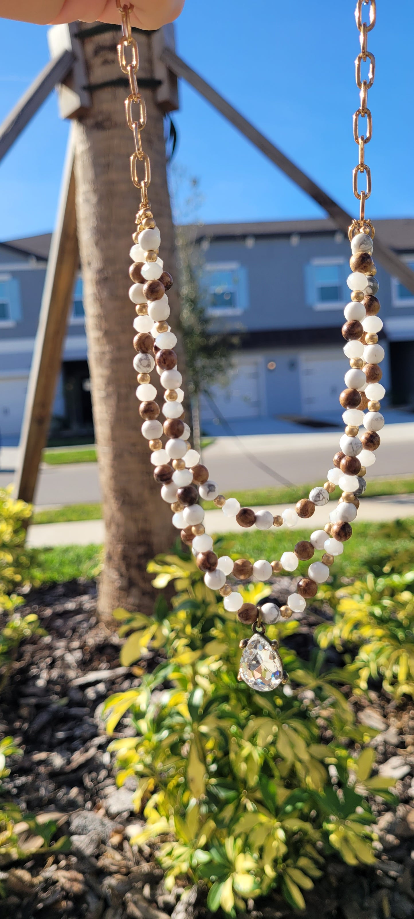 Pink Panache Necklace Triple strand white stone, wood bead and gold chain necklace with clear teardrop pendant Limited supply!