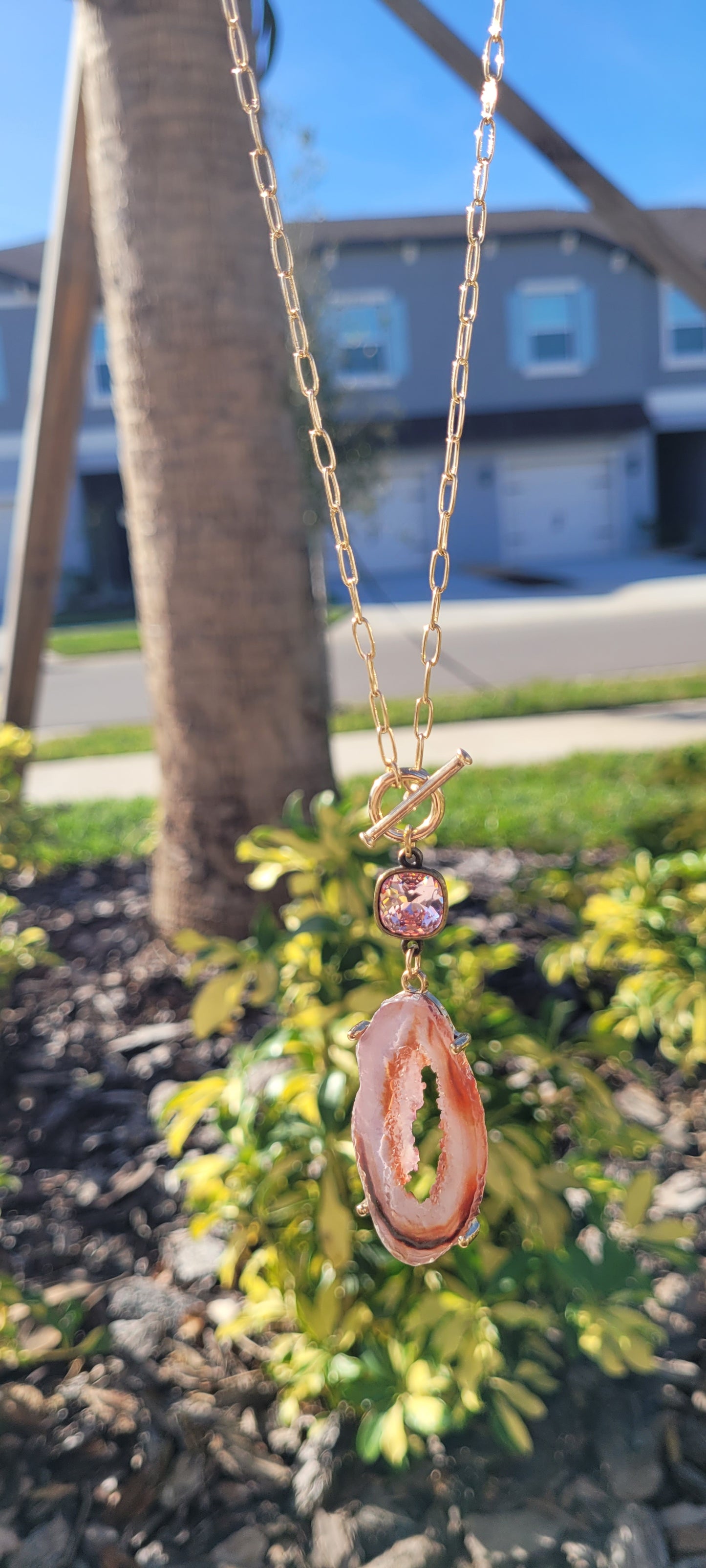 Pink Panache necklace Color: Long gold paperclip chain with toggle front and 10mm bronze/light rose cushion cut connector and open pink druzy pendant Limited supply!