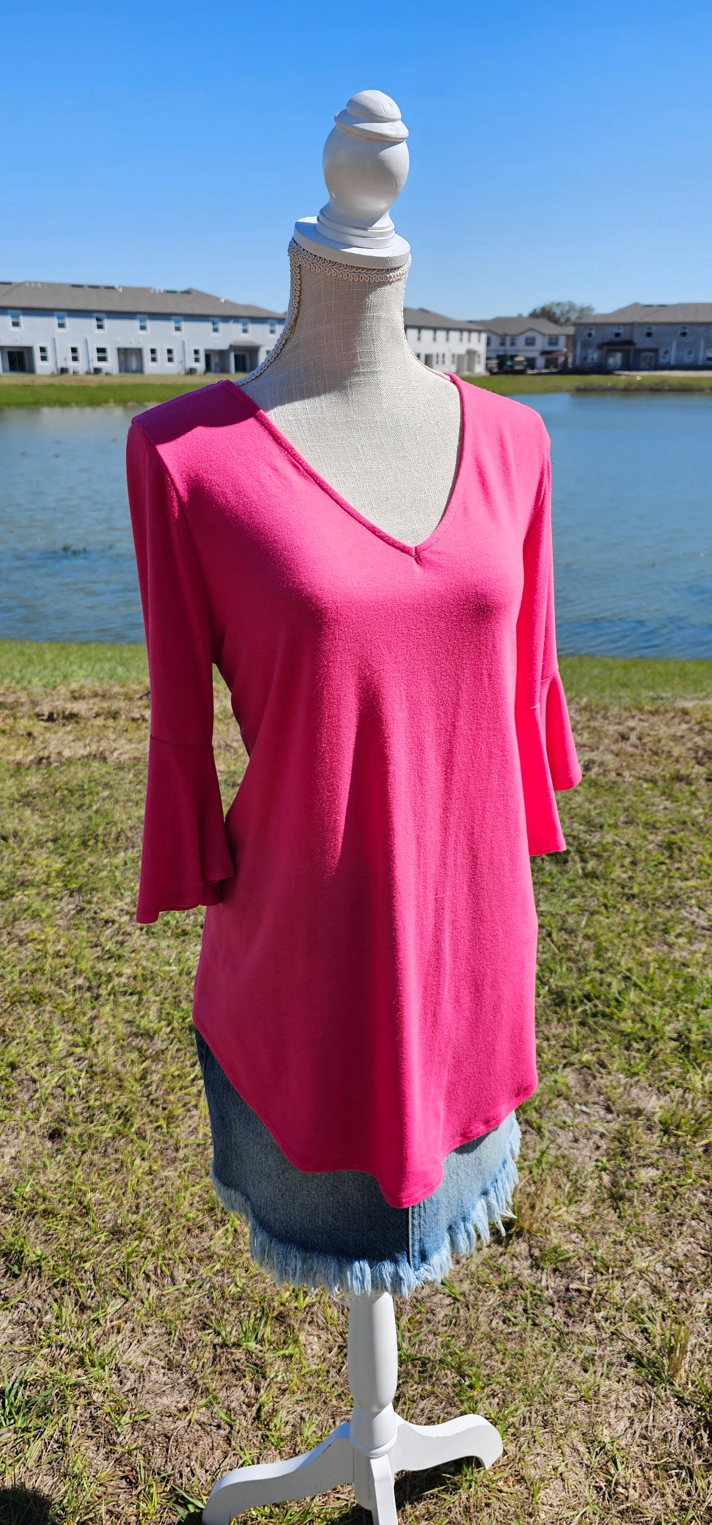 This is a comfy and casual top! This is a ruffled bell sleeve, rounded hem, v-neck shirt. Color is fuchsia. Easy to dress up or down. Pair with your favorite pair of denim jeans, shorts, skirt, or dress pants. Don’t be afraid to get creative! Sizes small through x-large.