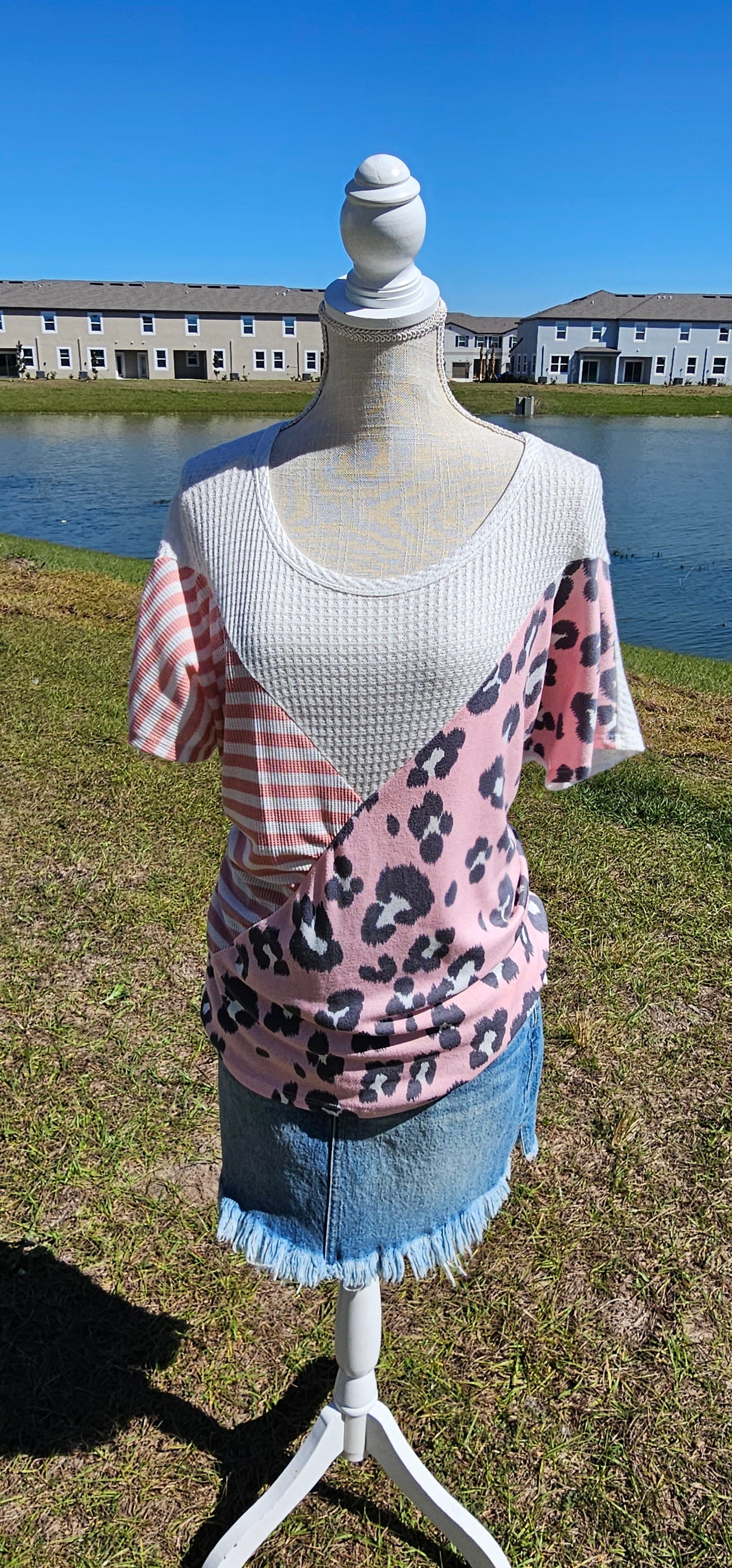 “Spoken From The Heart” is a comfy and casual t-shirt! This short sleeve shirt features pattern blocking, leopard print (pink, gray, white), stripes (coral, white) and solid waffle (white). This shirt has three different materials and textures, and a rounded neckline. Pair with your favorite pair of denim jeans, shorts, or skirt. Sizes small through large.