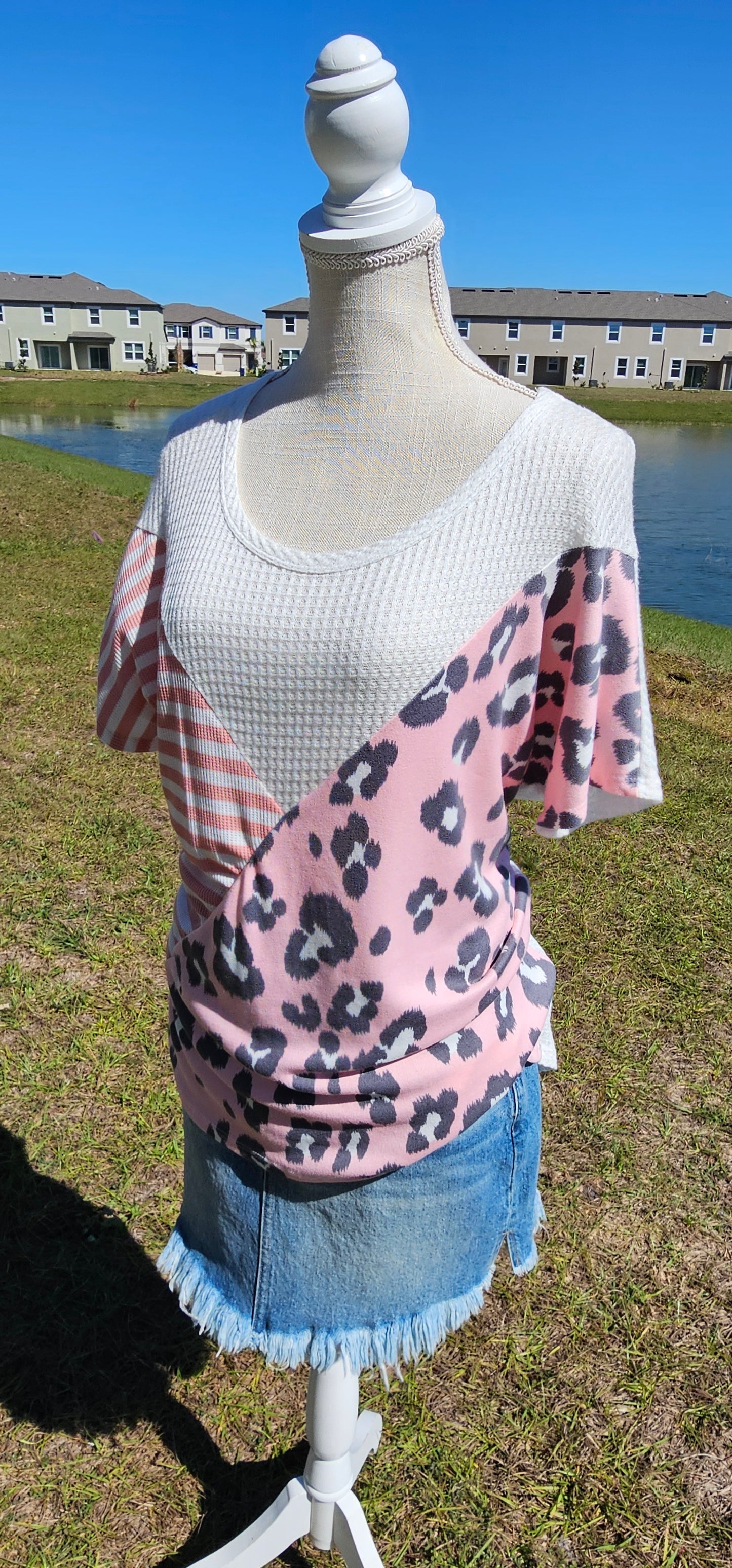 “Spoken From The Heart” is a comfy and casual t-shirt! This short sleeve shirt features pattern blocking, leopard print (pink, gray, white), stripes (coral, white) and solid waffle (white). This shirt has three different materials and textures, and a rounded neckline. Pair with your favorite pair of denim jeans, shorts, or skirt. Sizes small through large.