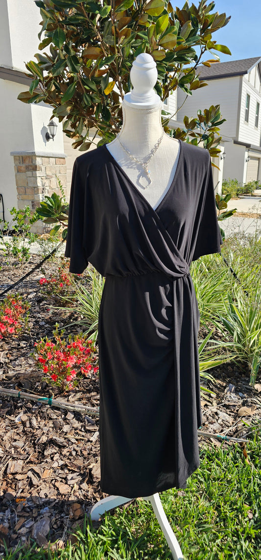 Style your look with this midi flutter sleeve dress. It features a surplice neckline and asymmetrical detail, making it a versatile style that's perfect for work or weekend wear. Sizes small through 3x-large.