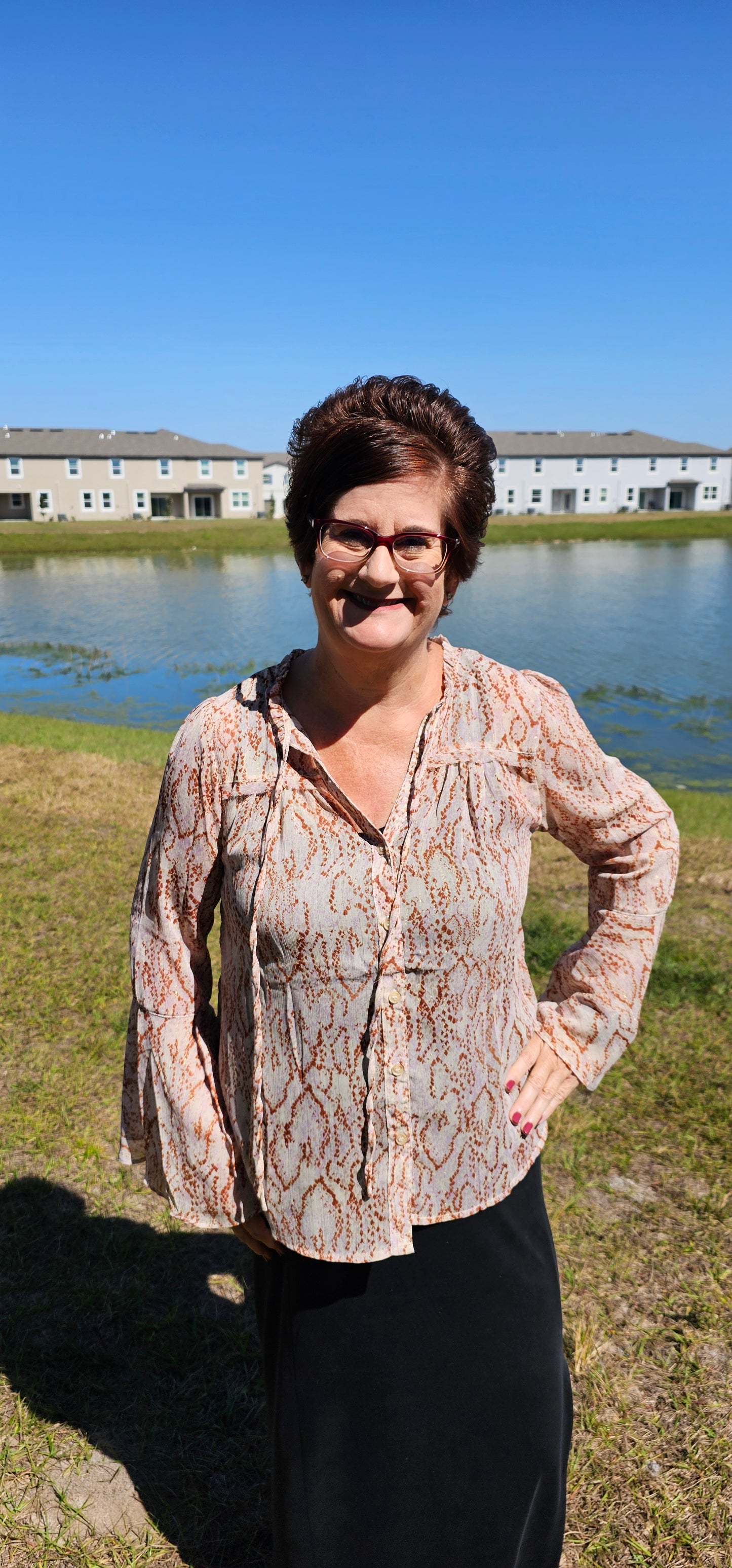 Say "hello, gorgeous!" to our "Charlotte Blush Chiffon Blouse"! This beauty features a flirty V-neck with tie strap, ruffled bell sleeve, and a button front closure for a dash of sophistication. Plus, it's made with semi-sheer, shimmering lurex chiffon for a touch of luxury that won't break the bank. The charmer of the party, indeed! Sizes small through large.