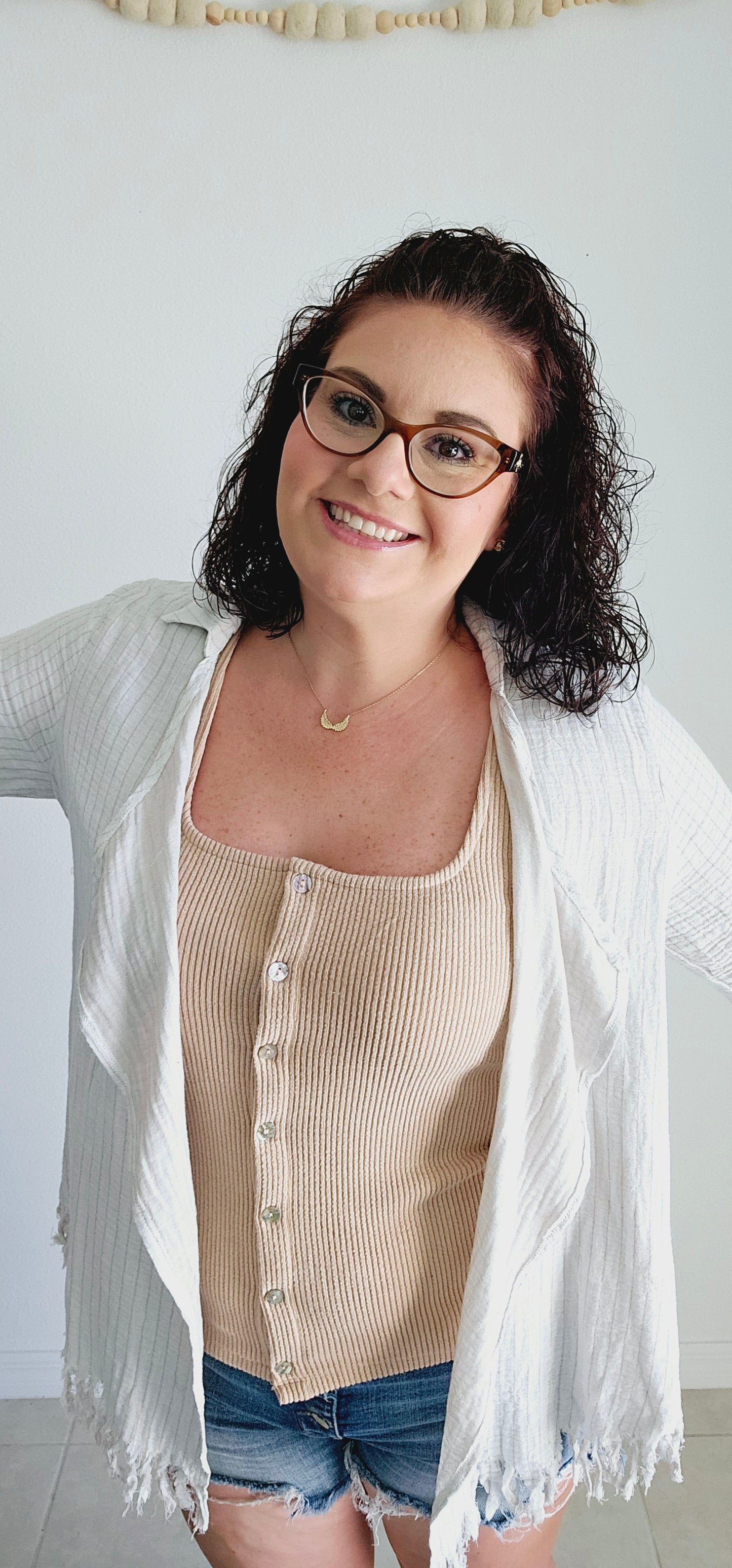 This tank top features a unique square neckline and a classic ribbed design in a washed tan color. Perfect for layering or wearing on its own, this tank is a versatile addition to your wardrobe. Sizes small through large.