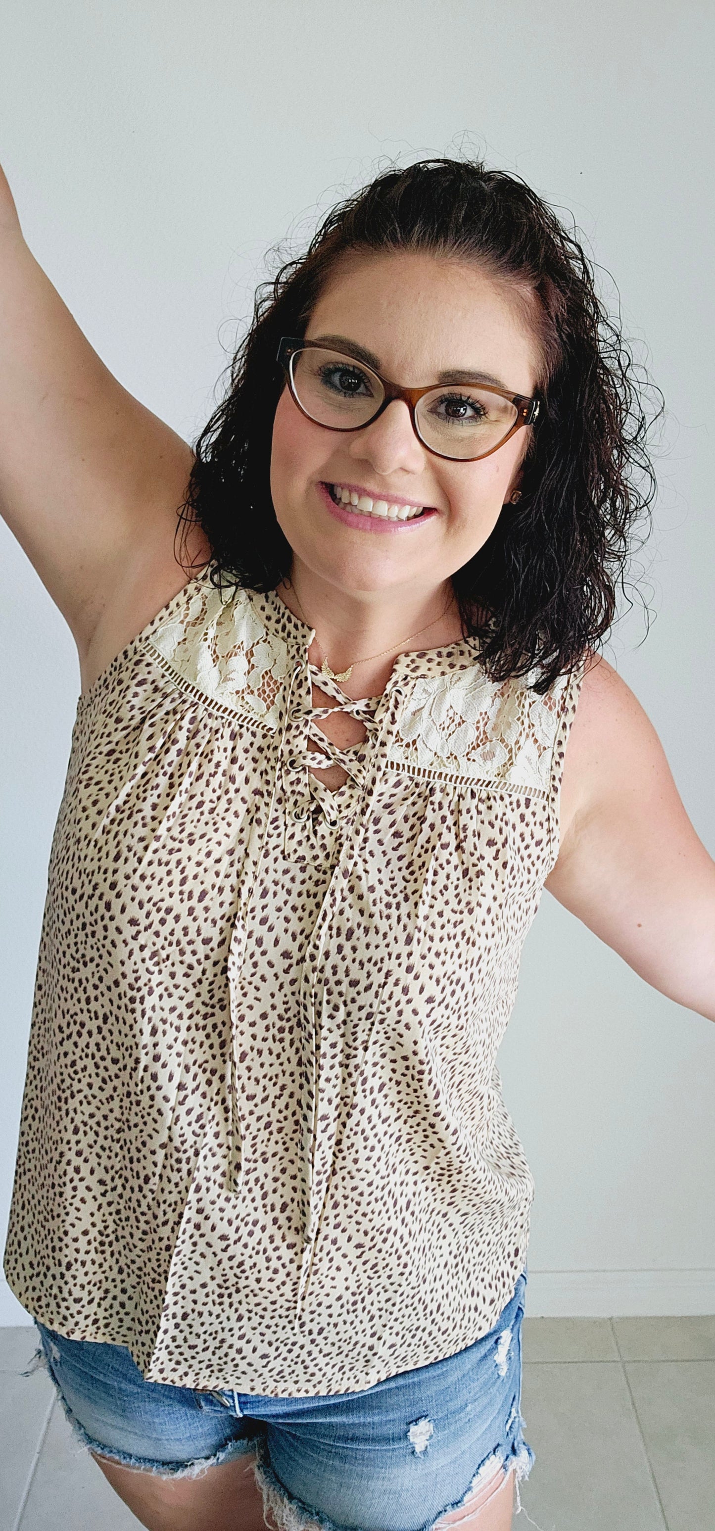 Unleash your wild side in this sleeveless top! This fierce top features a playful leopard print and a delicate lace yoke for a touch of elegance. With a sexy lace-up v-neck, you'll be turning heads wherever you go. Roar with style in beige! Sizes small through large.