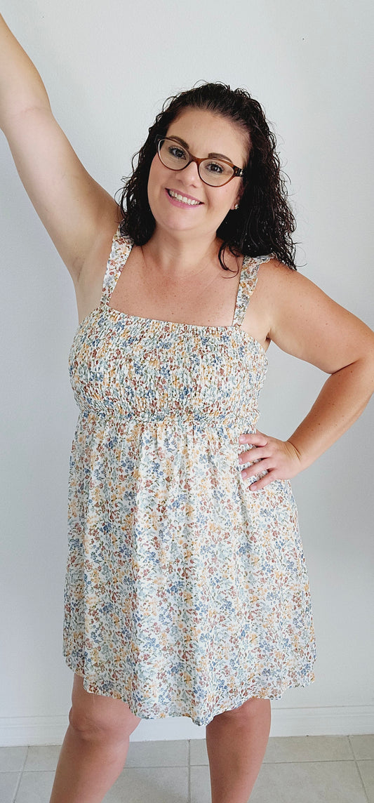 Stay cool and stylish this summer with this adorable dress! Featuring ruffle straps, smocking on the chest, and a trendy ditsy print, this dress is perfect for any summer occasion. Don't sacrifice comfort for style - this mini dress has got you covered. Sizes small through large.