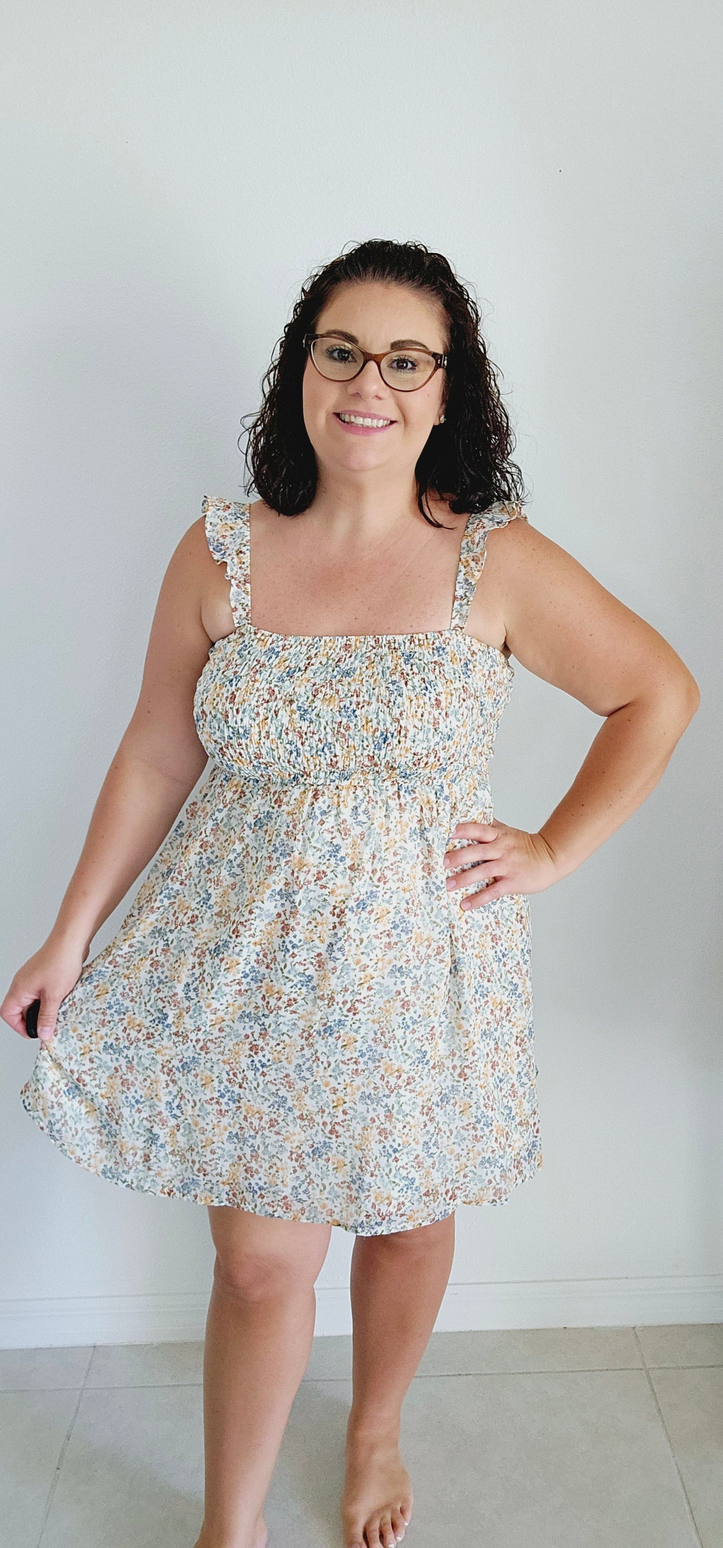Stay cool and stylish this summer with this adorable dress! Featuring ruffle straps, smocking on the chest, and a trendy ditsy print, this dress is perfect for any summer occasion. Don't sacrifice comfort for style - this mini dress has got you covered. Sizes small through large.