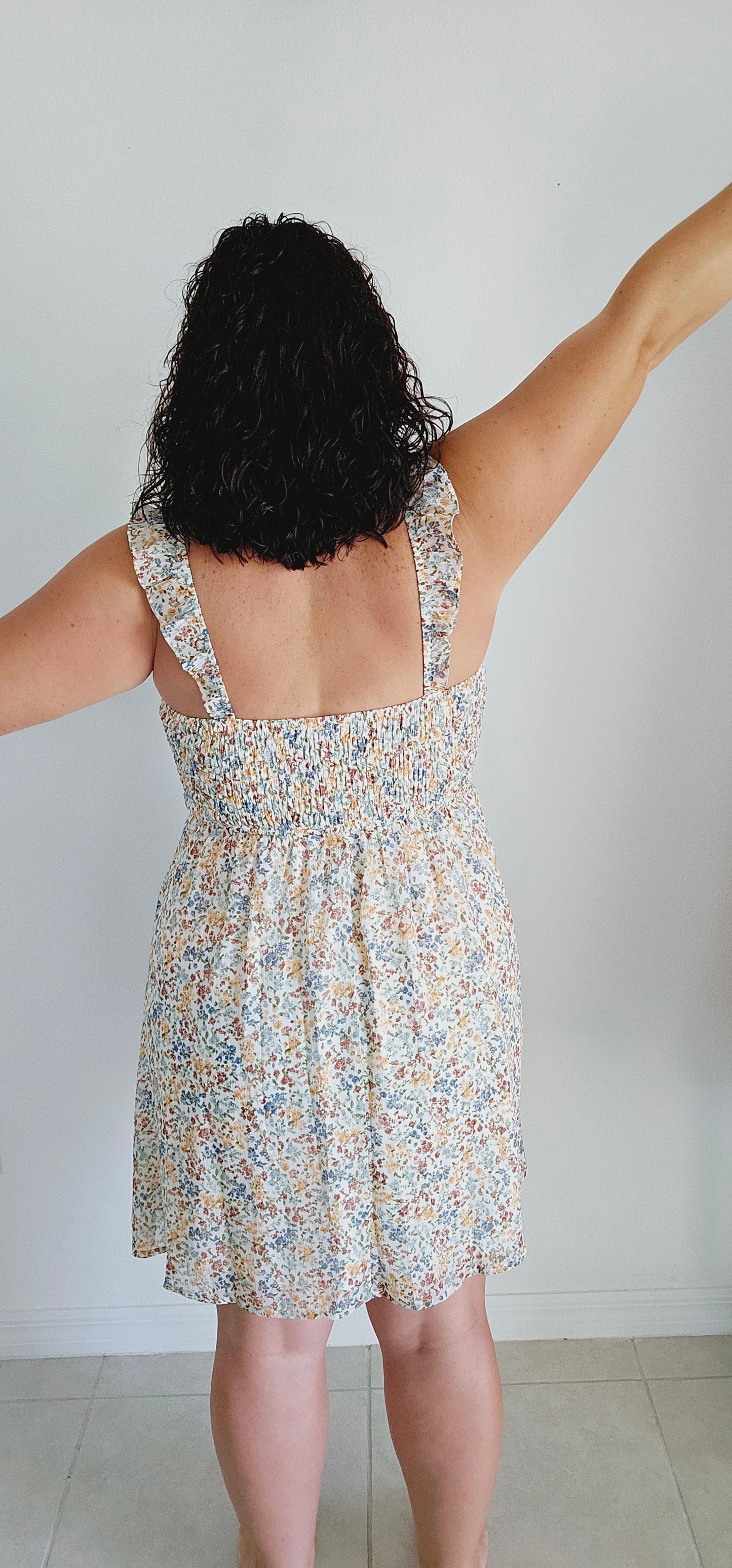 Stay cool and stylish this summer with this adorable dress! Featuring ruffle straps, smocking on the chest, and a trendy ditsy print, this dress is perfect for any summer occasion. Don't sacrifice comfort for style - this mini dress has got you covered. Sizes small through large.