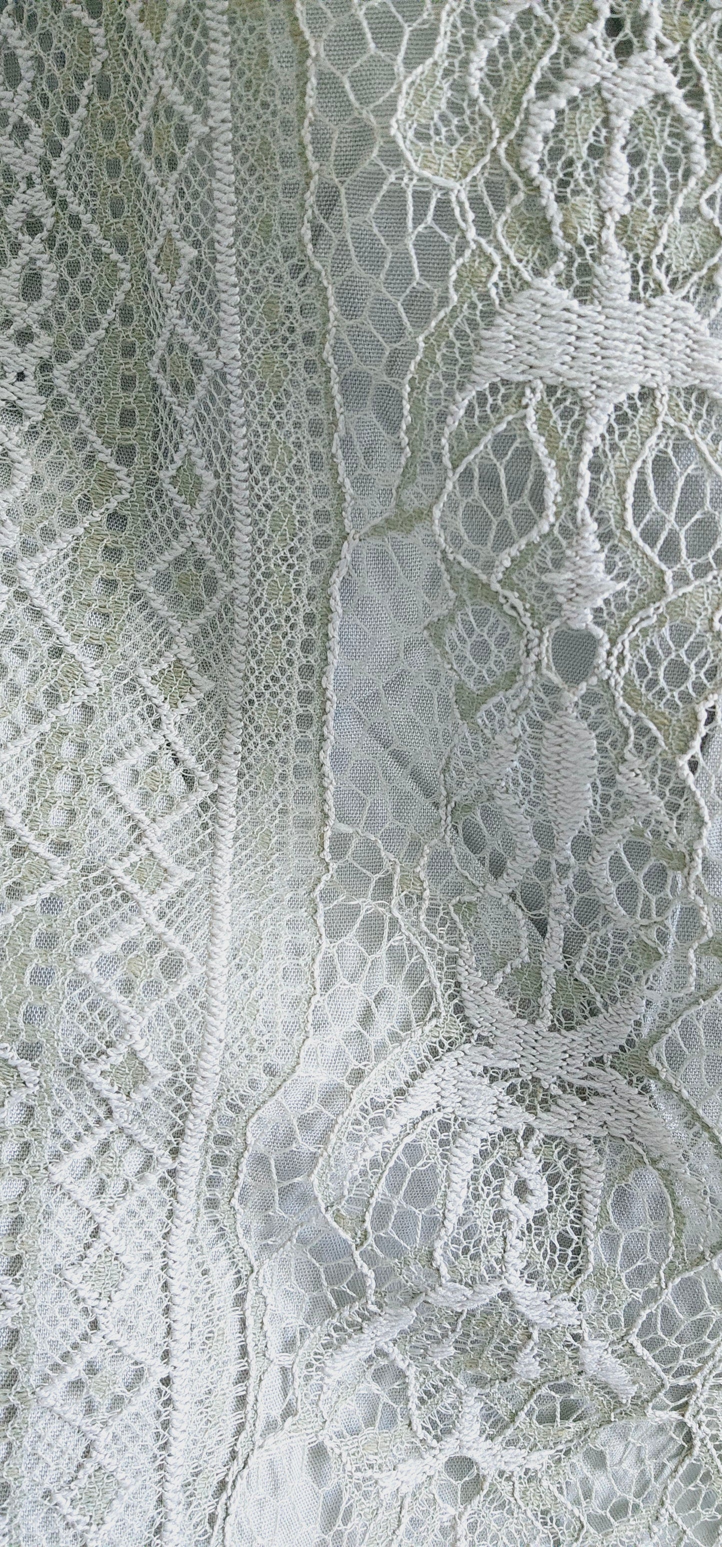 This A-line slip dress features a delicate lace overlay and a flattering waist tie, perfect for accentuating your figure. With adjustable shoulder straps and a soft rayon lining, this dress is both stylish and comfortable. Wear it to your next event for a touch of elegance with a modern twist. Sizes small through large.