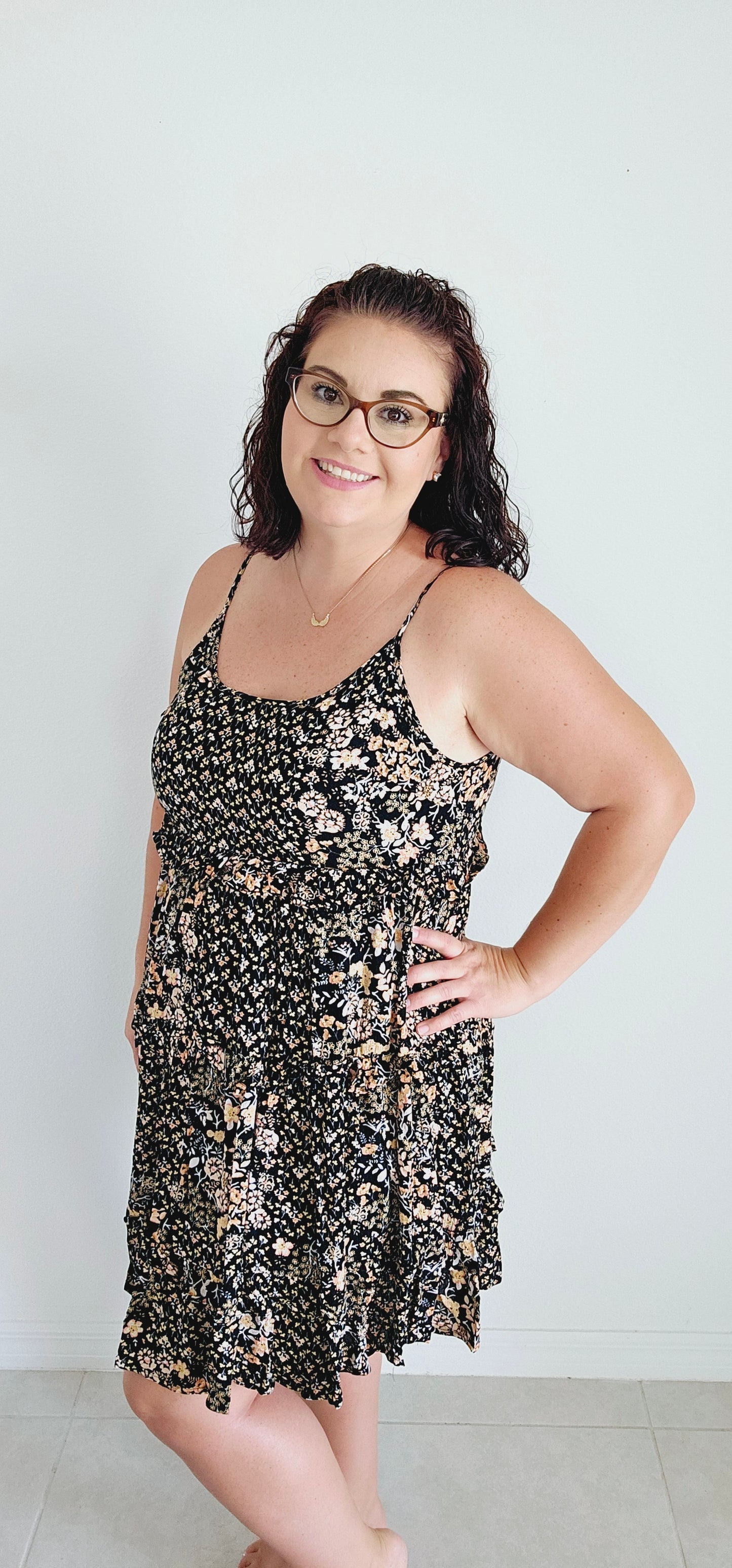Dress to impress in this mini dress! With a playful floral pattern, adjustable spaghetti straps, and a tie back, this dress is perfect for any occasion. The tiered ruffles add a touch of whimsy to your look. Sizes small through large.