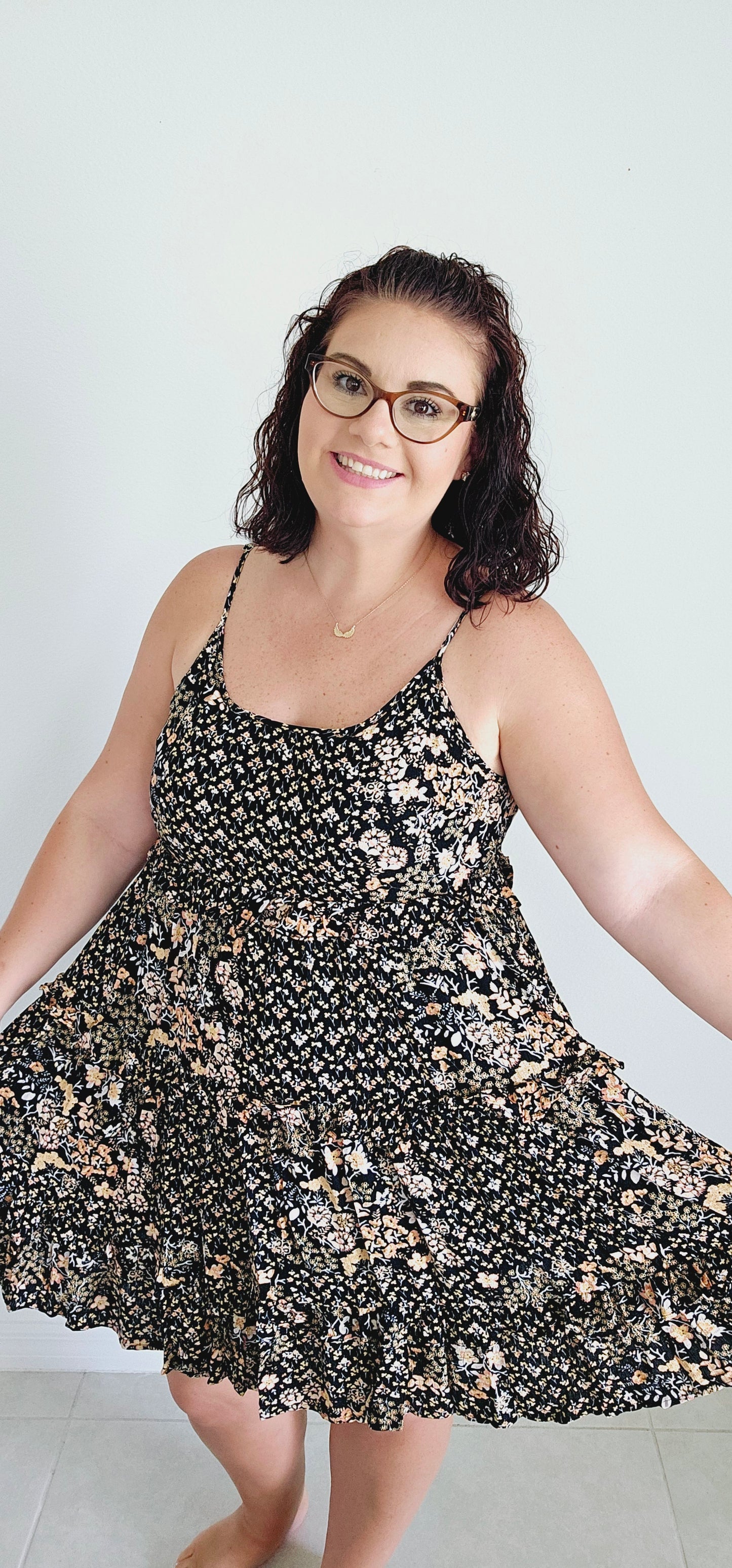 Dress to impress in this mini dress! With a playful floral pattern, adjustable spaghetti straps, and a tie back, this dress is perfect for any occasion. The tiered ruffles add a touch of whimsy to your look. Sizes small through large.