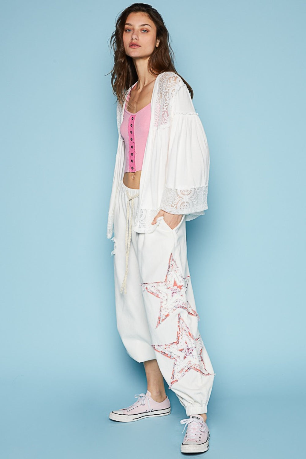 The designed open front oversized fit cardigan with 3/4 length bell sleeves is a chic layering piece for any outfit. Crafted from a mix of jersey and lace, this cardigan combines comfort with a touch of elegance. The frayed edge detail on the entire garment adds a contemporary and edgy vibe, giving it a unique and textured look. S-L