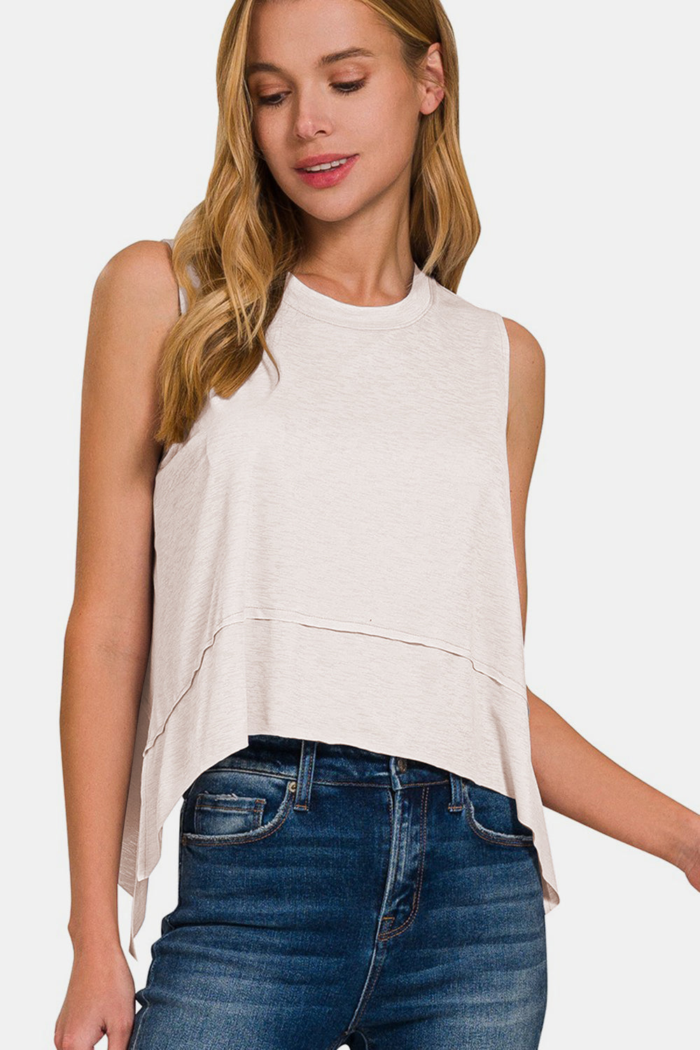 The Slit High-Low Round Neck Tank is a chic and trendy top that adds a touch of sophistication to any outfit. Featuring a stylish high-low hem with side slits, this tank offers a modern twist on a classic silhouette. The round neck design creates a flattering neckline, while the sleeveless style is perfect for warm weather or layering under a cardigan or jacket. S-L