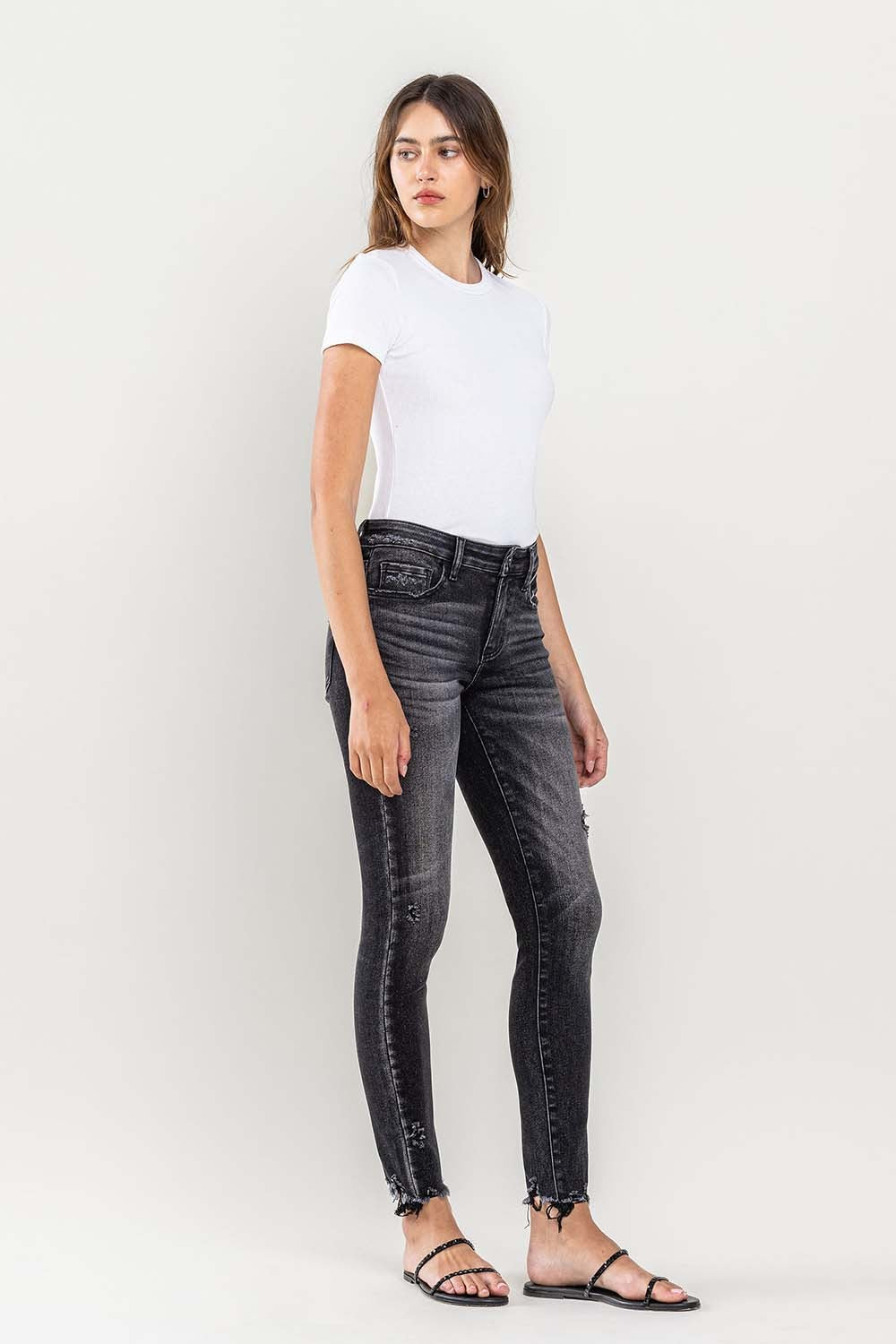 These raw hem cropped skinny jeans are a must-have for any fashion-forward individual. The raw hem adds a touch of edge to the classic skinny jeans silhouette. The cropped length is perfect for showcasing your favorite footwear. 24-32