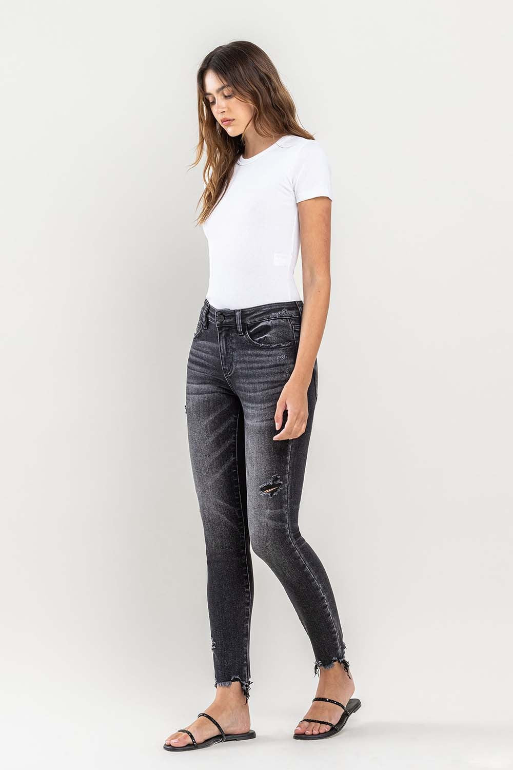 These raw hem cropped skinny jeans are a must-have for any fashion-forward individual. The raw hem adds a touch of edge to the classic skinny jeans silhouette. The cropped length is perfect for showcasing your favorite footwear. 24-32