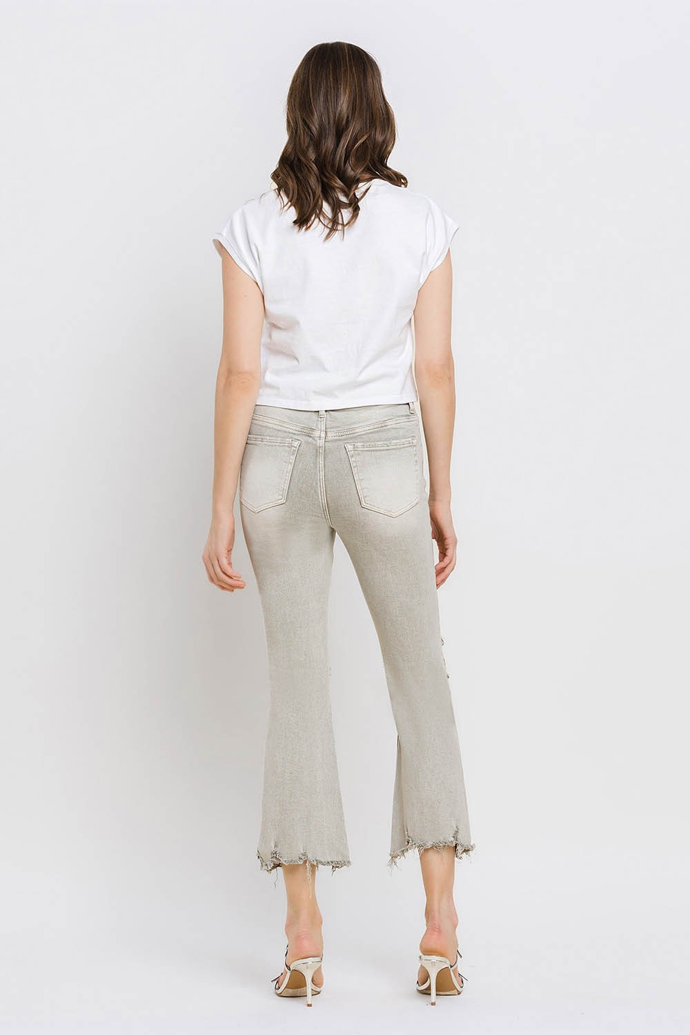 These distressed raw hem cropped flare jeans offer a perfect blend of edgy and retro style. The distressed detailing adds a touch of urban flair to the flared silhouette. The raw hem finishes off the look with a trendy, unfinished edge. Pair these jeans with a tucked-in graphic tee and platform sandals for a vintage-inspired outfit.  24-32