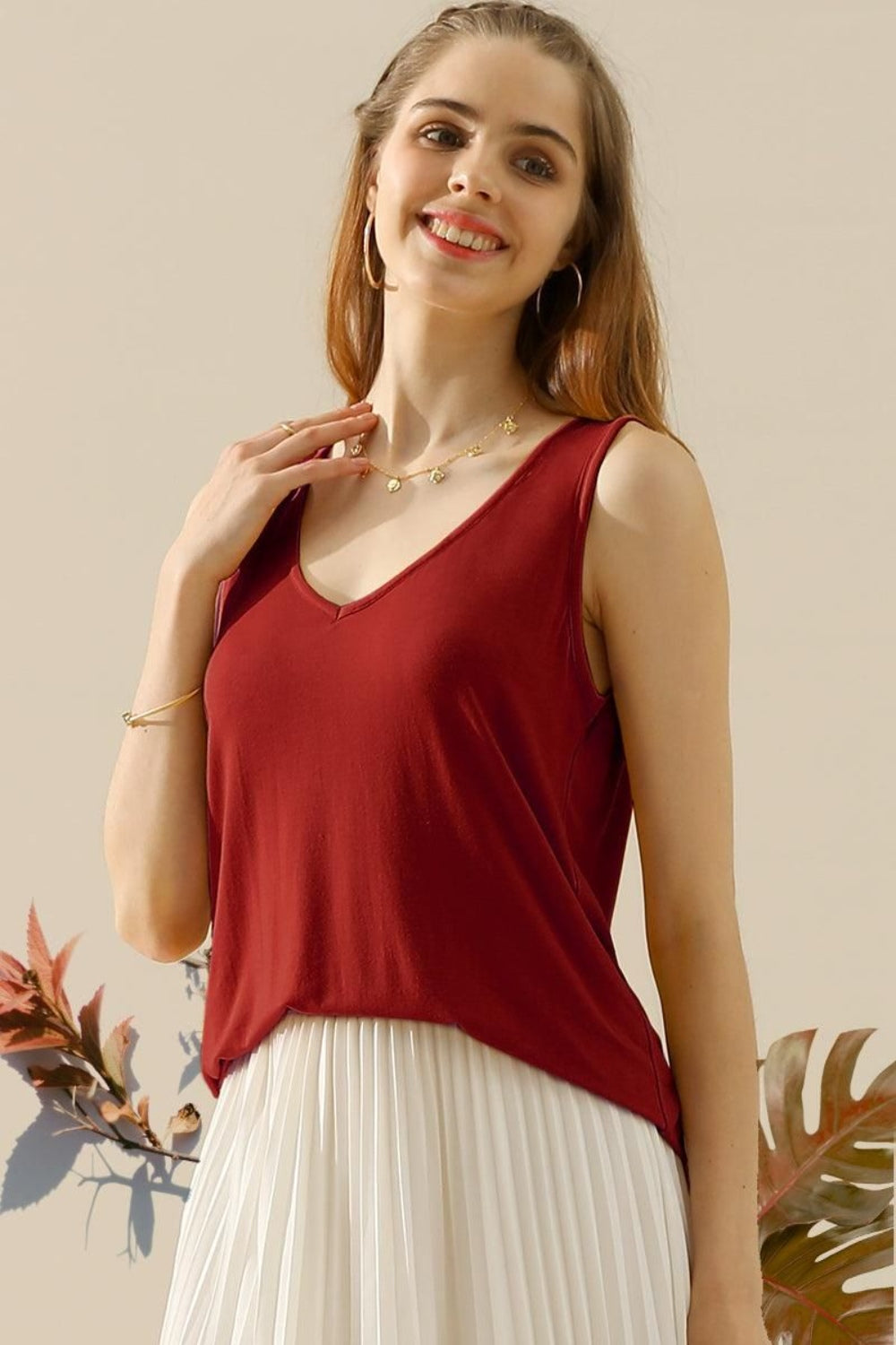 The V-Neck Curved Hem Tank is a stylish and versatile piece. With its flattering neckline and curved hem, it adds a touch of femininity to any outfit. The tank's relaxed fit provides comfort without sacrificing style. S - XL
