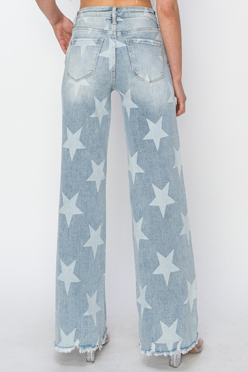 The Raw Hem Star Wide Leg Jeans are a fashionable and eye-catching choice for those looking to make a statement with their outfit. The raw hem detail gives these jeans a casual and edgy vibe, while the star embellishments add a touch of whimsical charm. The wide leg silhouette offers a comfortable and flattering fit, making them a versatile piece that can be dressed up or down. 0-3X